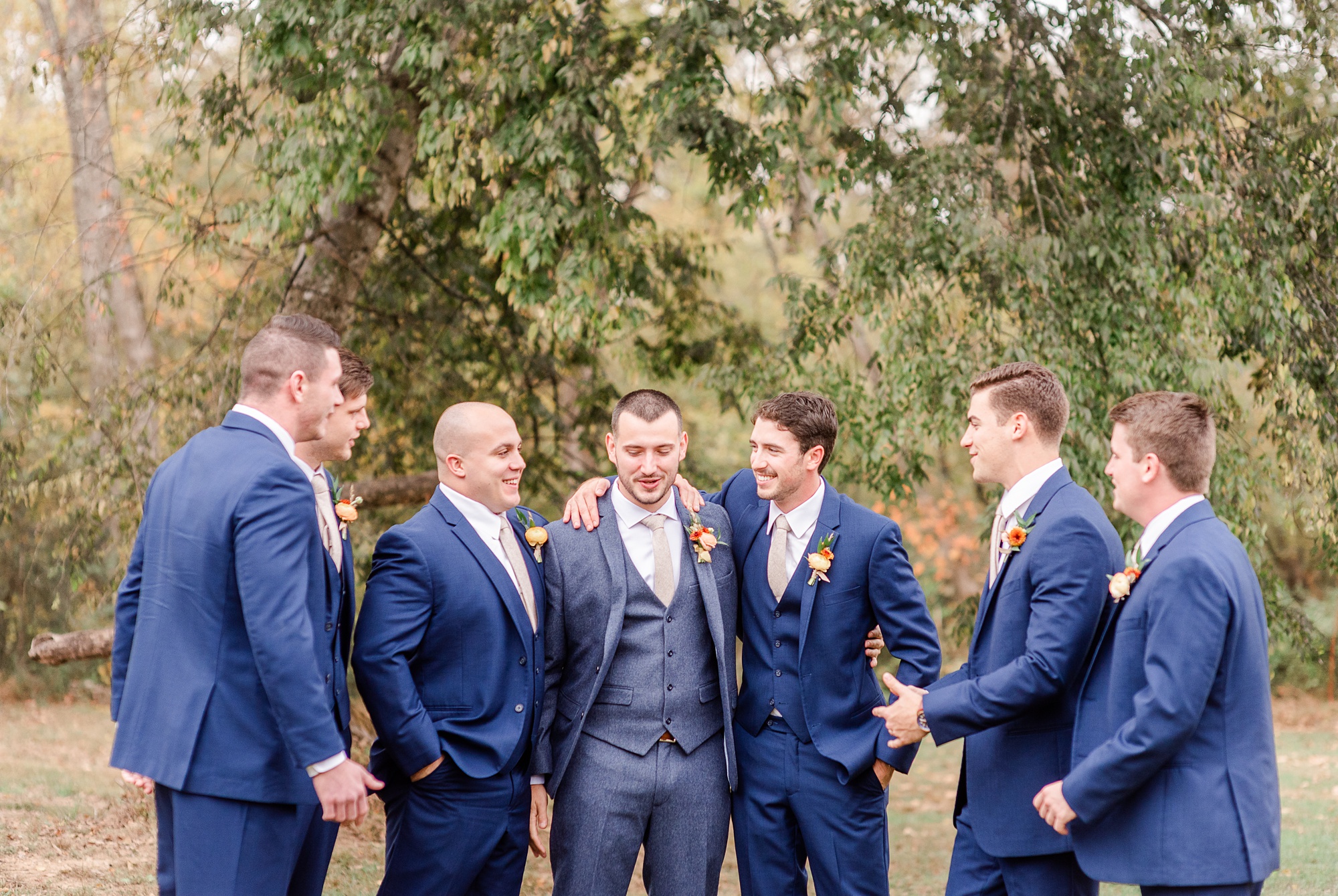 groom laughs with groomsmen during Providence Cotton Mill wedding day