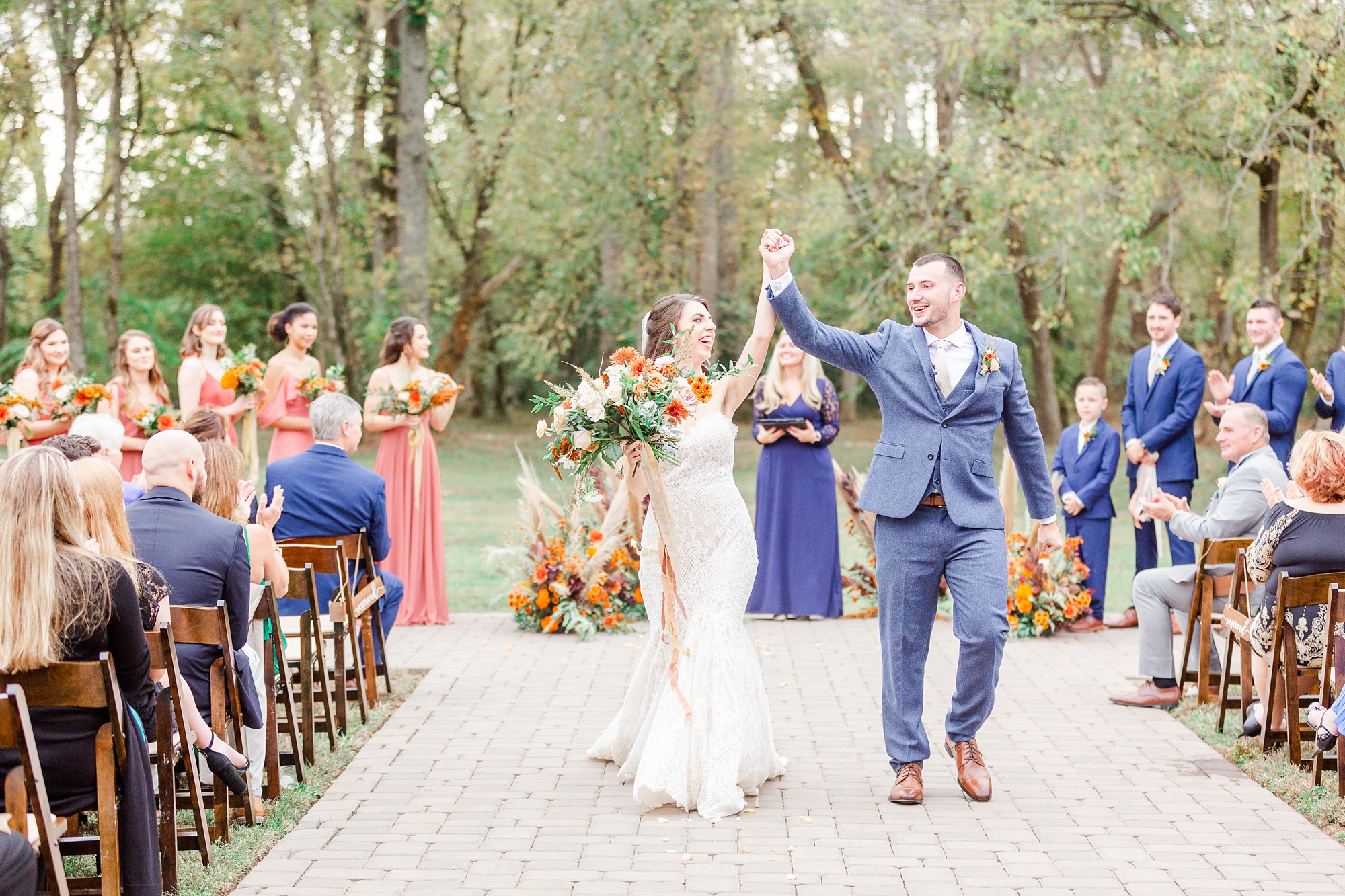 newlyweds walk up aisle cheering after wedding ceremony