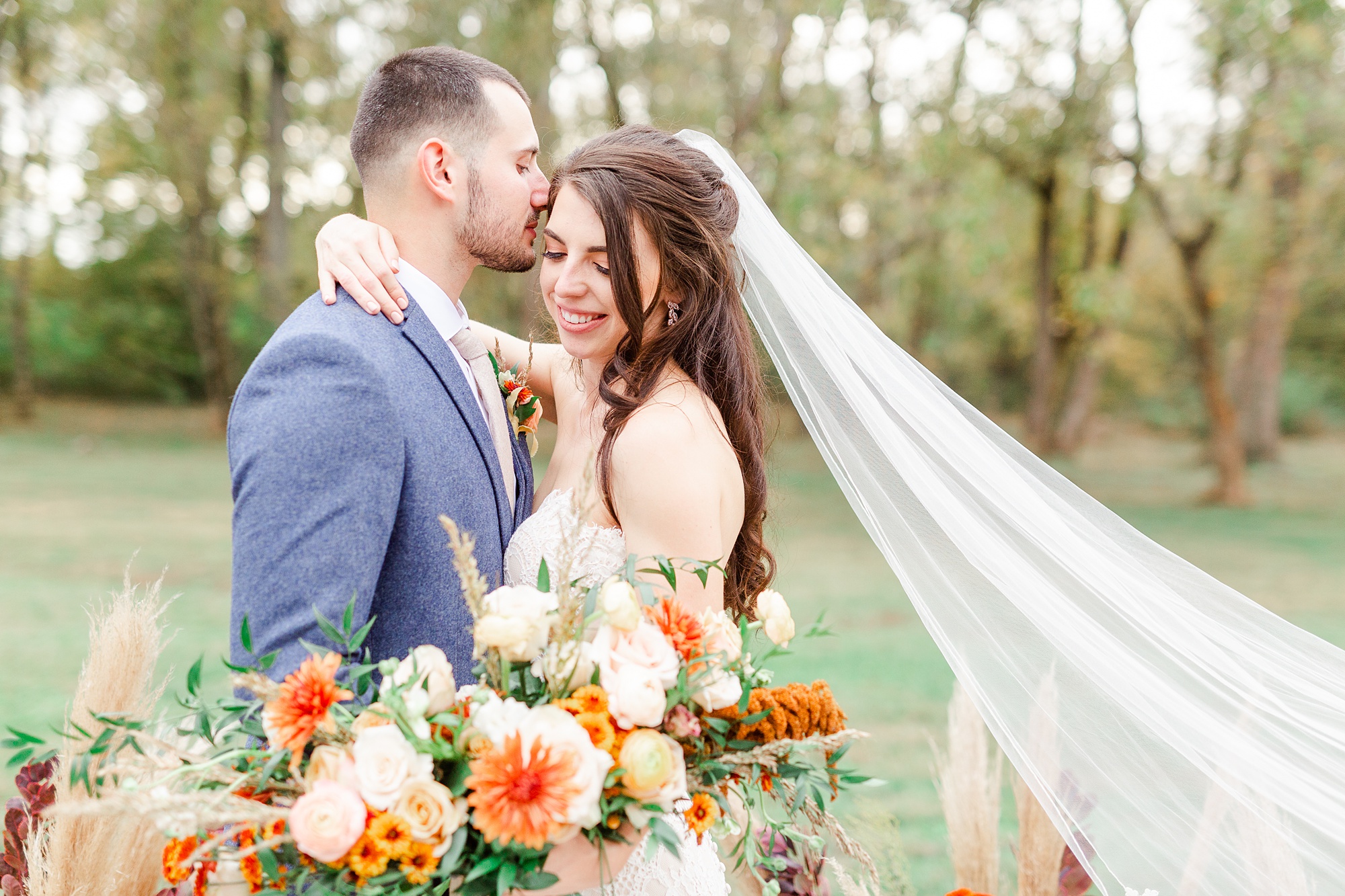 groom kisses bride's forehead during Providence Cotton Mill wedding photos
