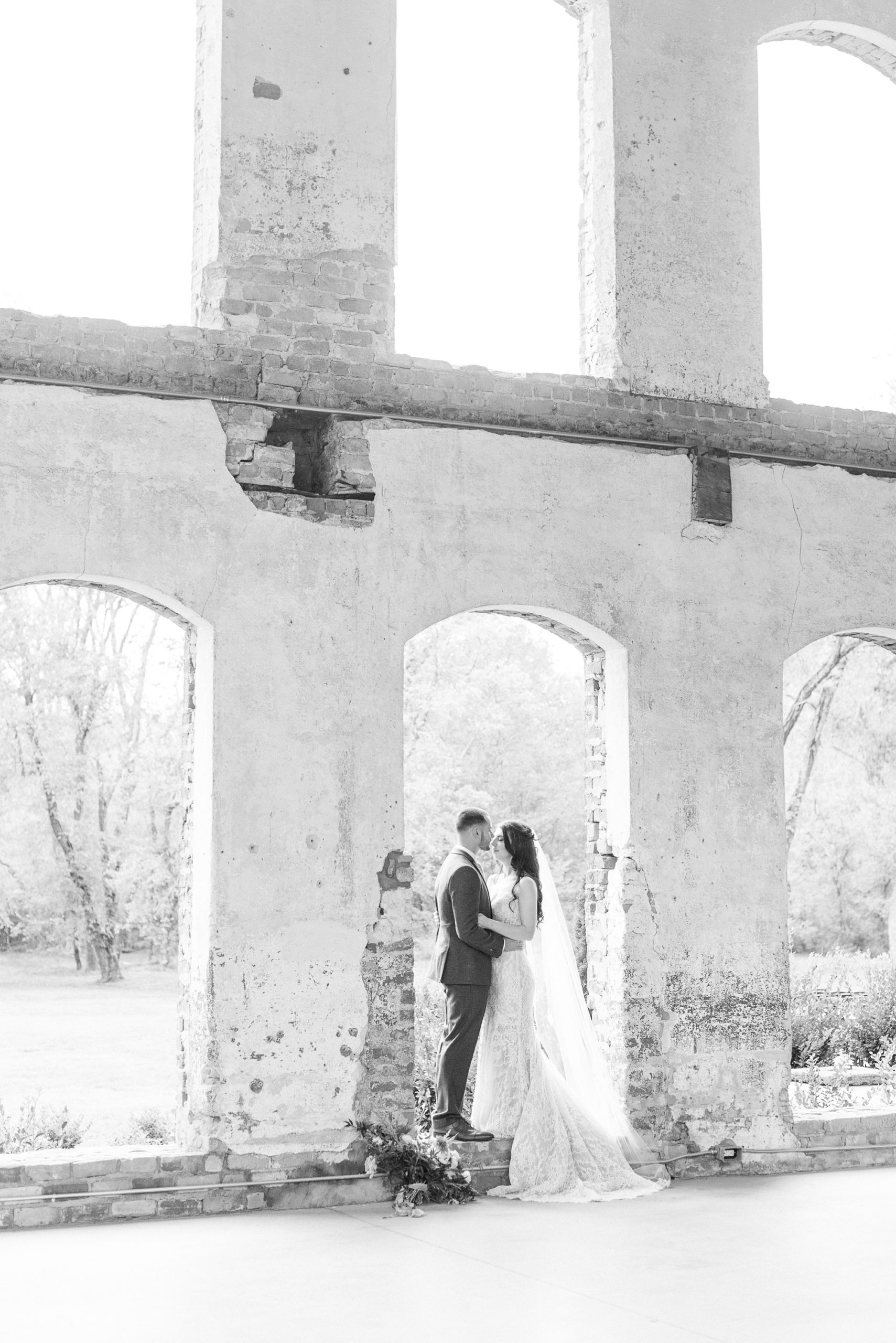 Providence Cotton Mill wedding portraits of bride and groom in tall window