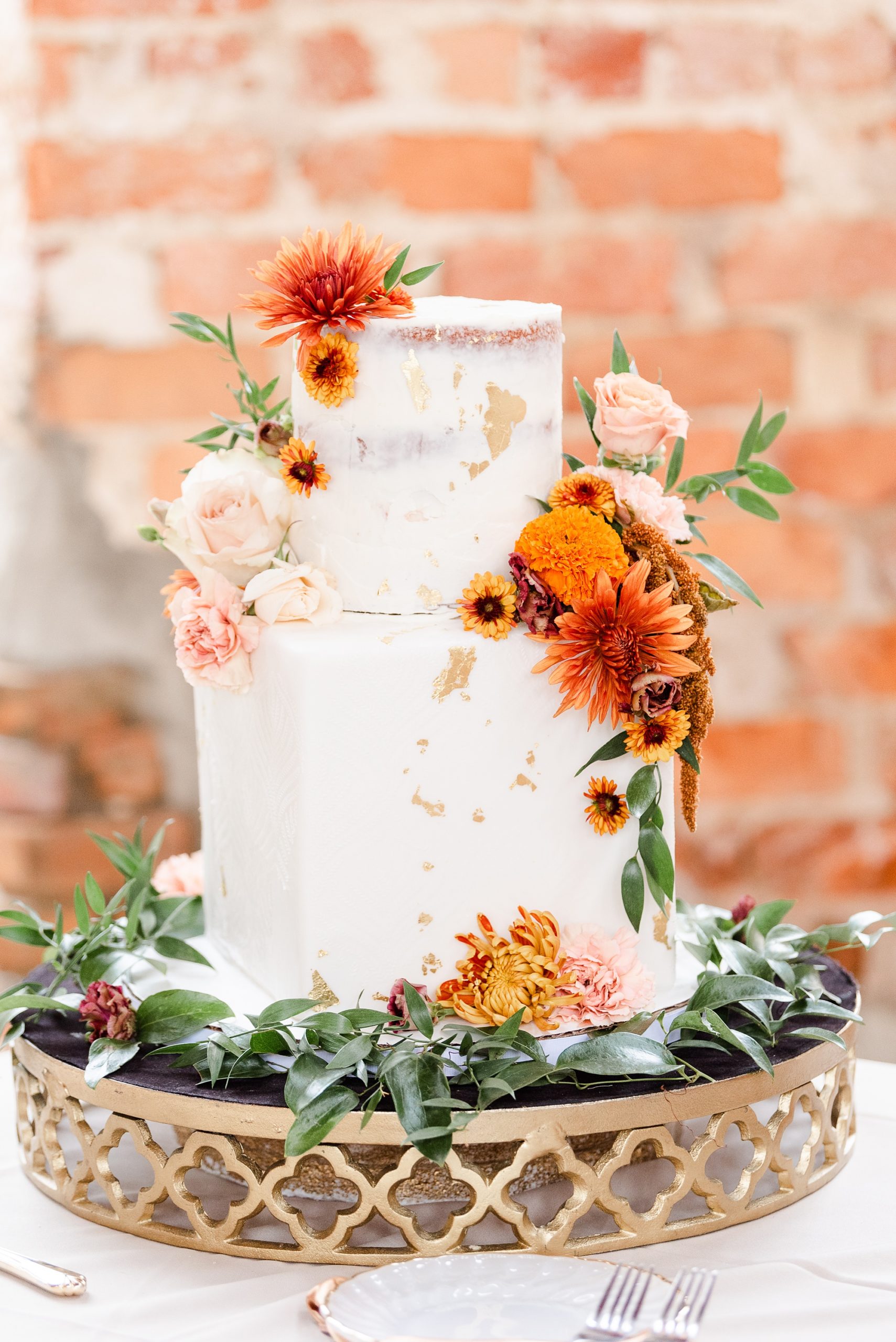 tiered wedding cake with orange flowers