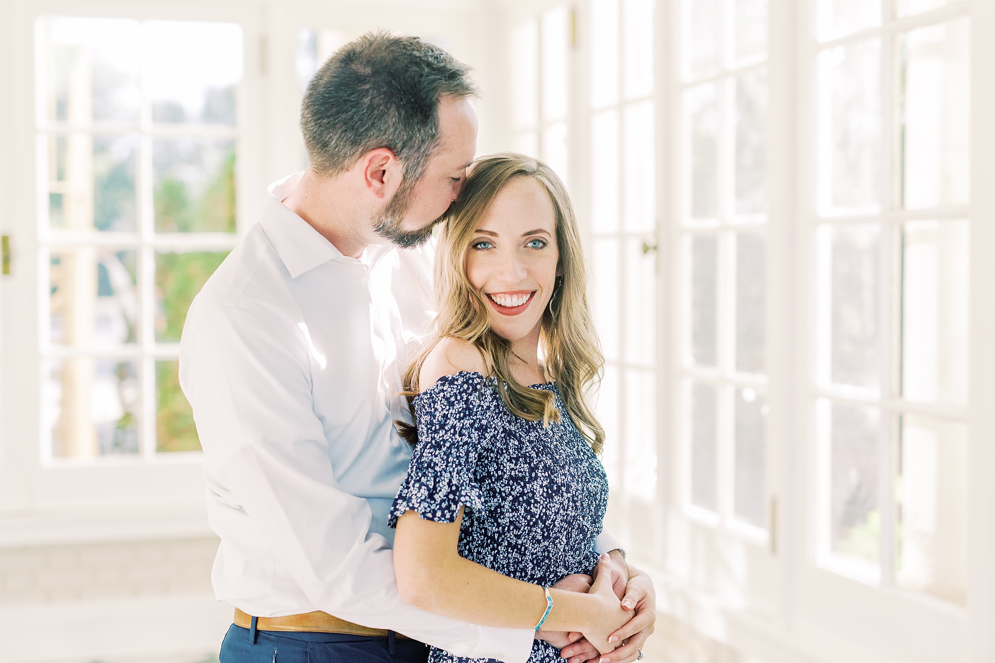 groom kisses bride's temple during NC engagement portraits at Separk Mansion
