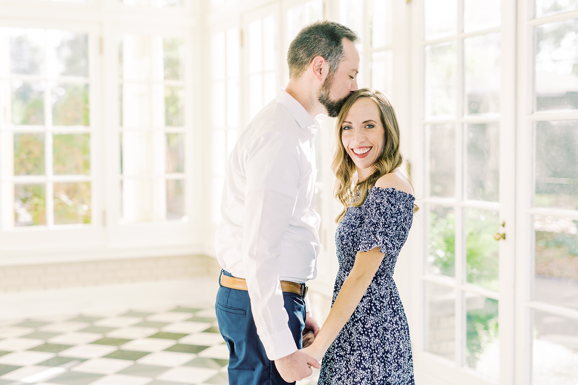 groom kisses bride's head during Separk Mansion engagement session