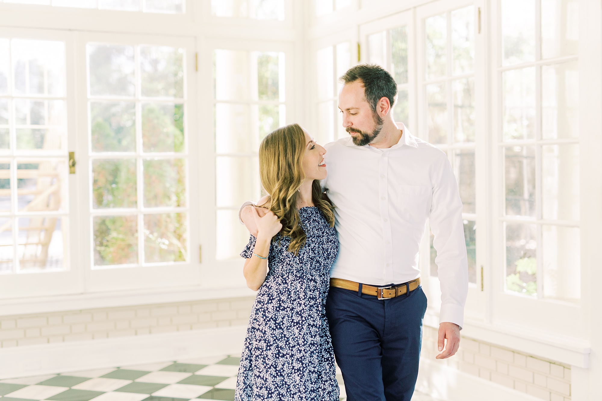 bride and groom walk through Separk Mansion with groom's arm around bride