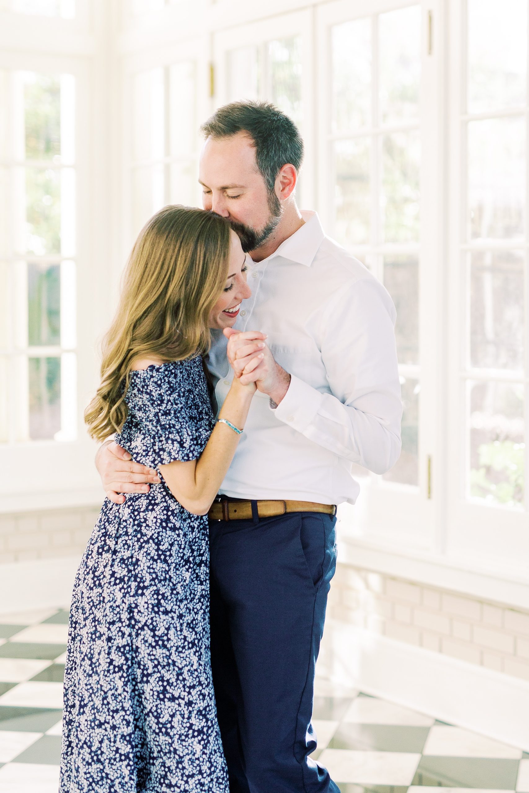 groom kisses bride's head during Separk Mansion engagement session