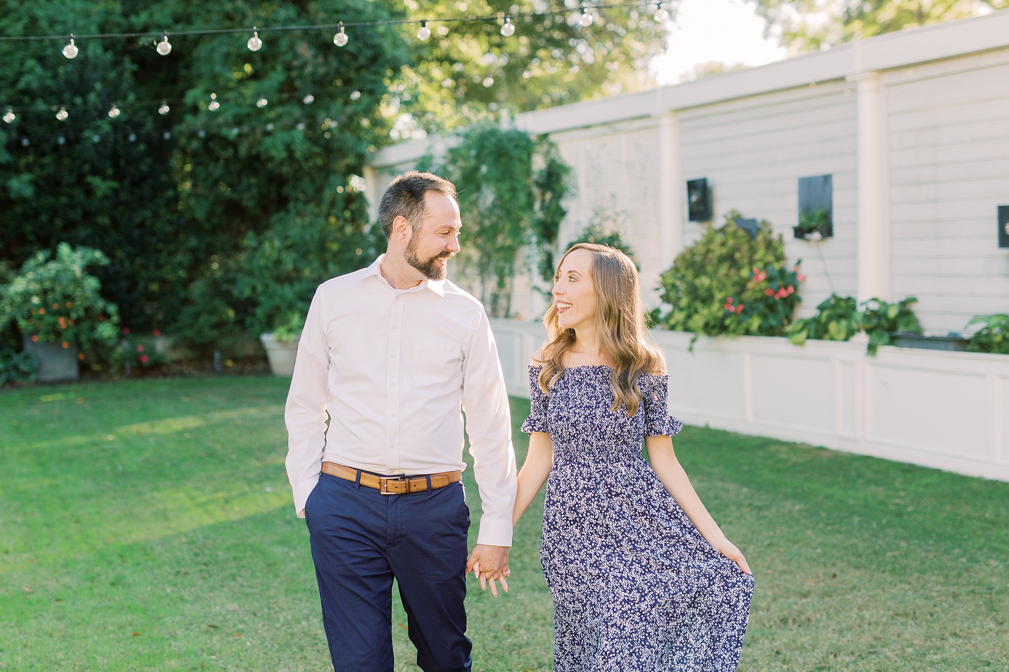engaged couple walks through yard at Separk Mansion