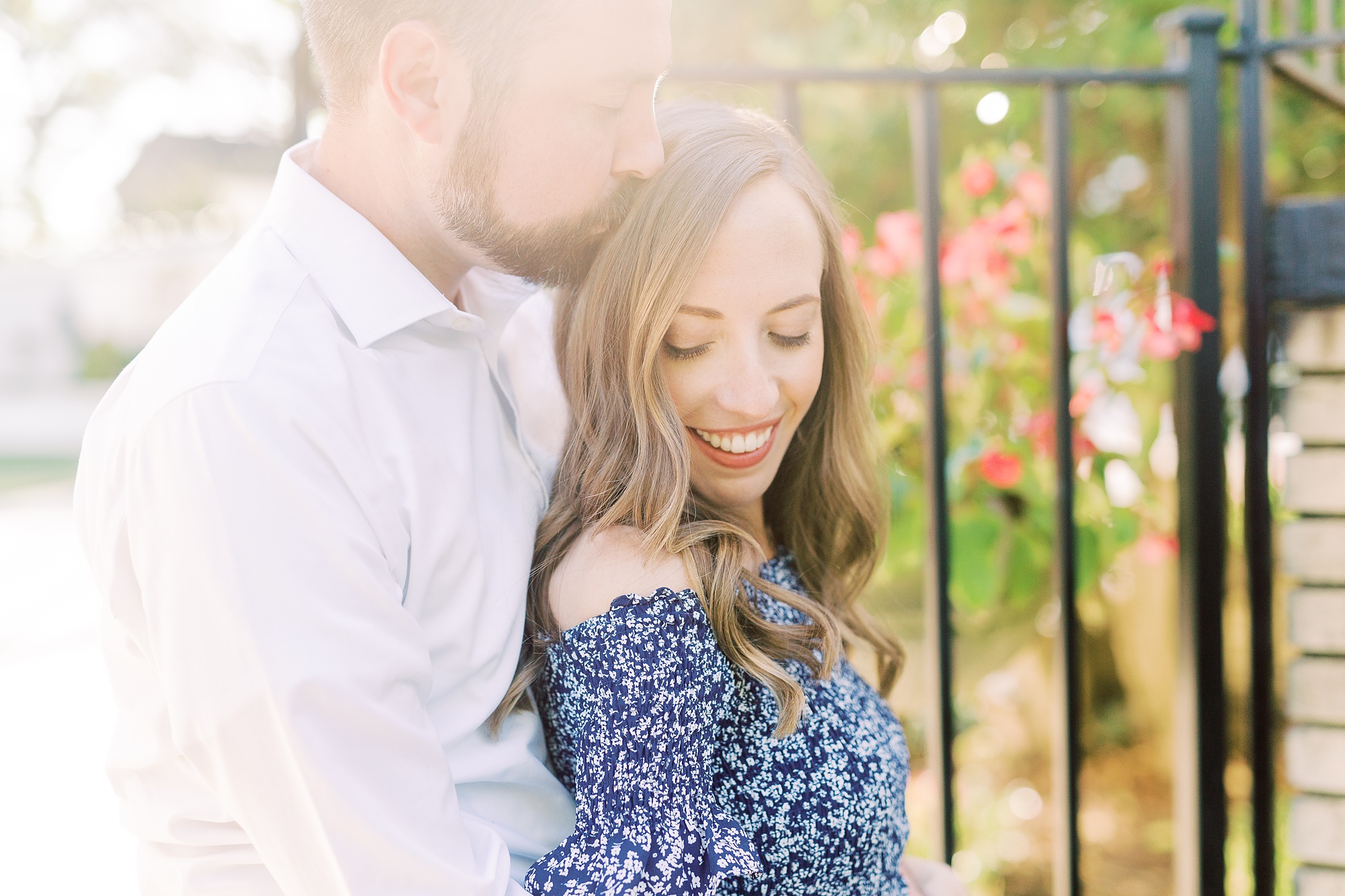 bride and groom pose by iron gate during Gastonia NC engagement session