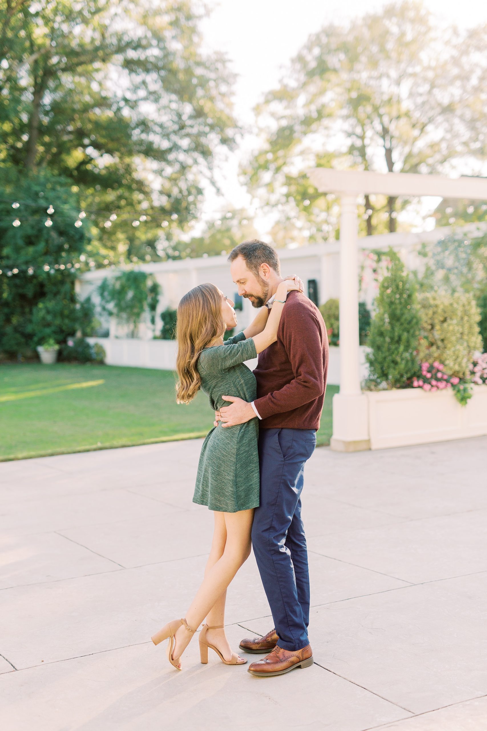 bride and groom pose on patio during Gastonia NC engagement session