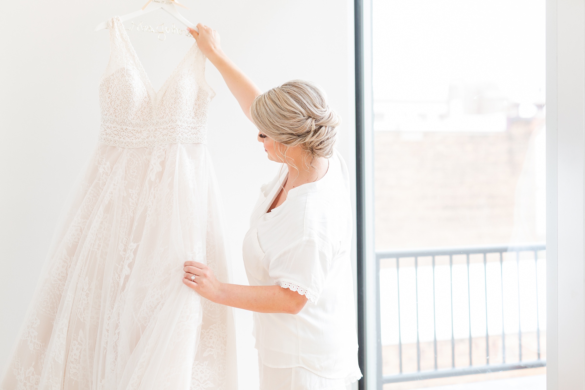 bride looks at wedding dress