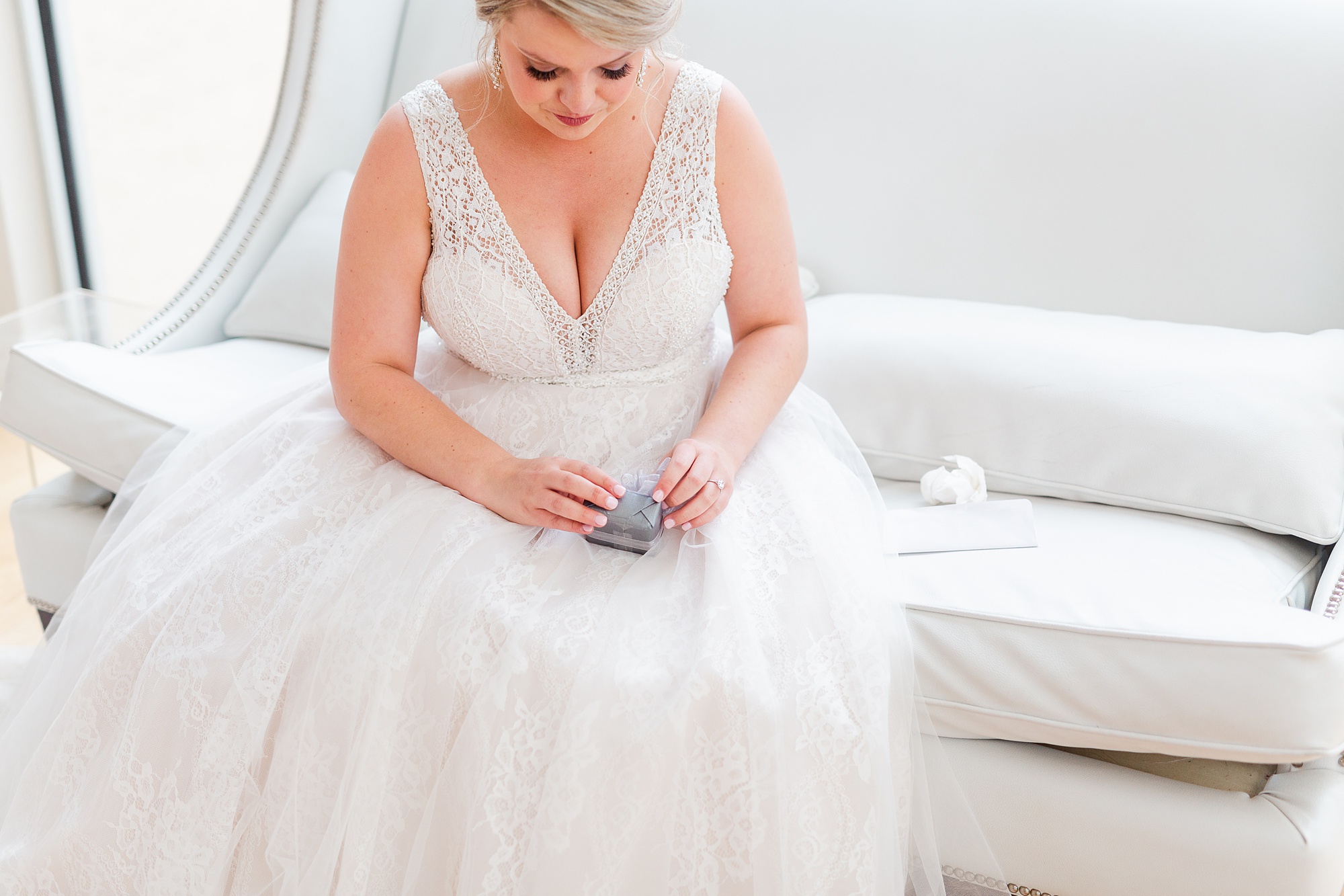 bride opens gift on wedding day in Raleigh