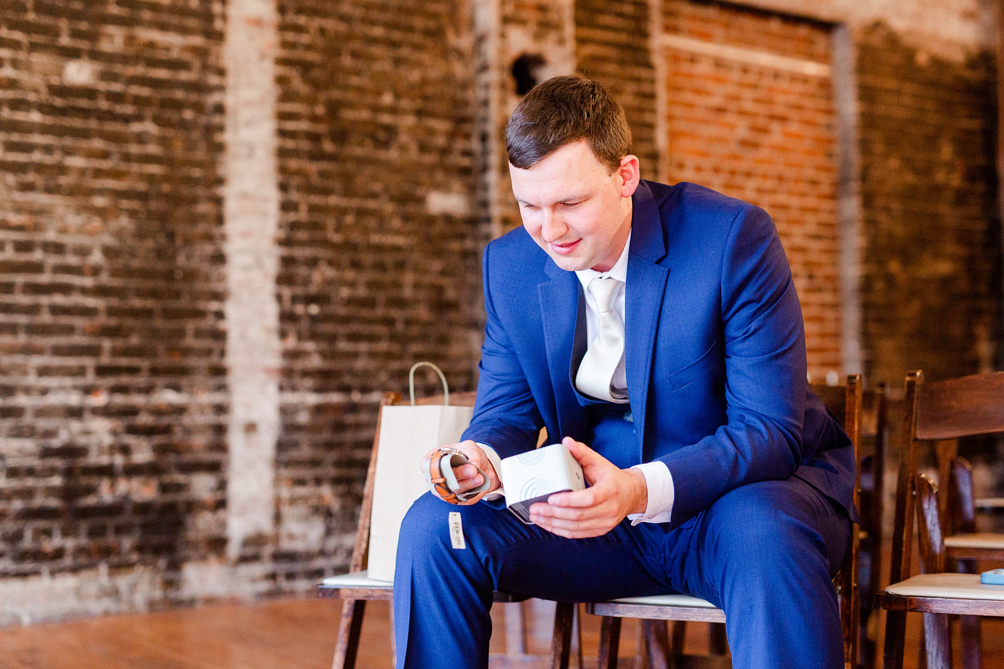groom reads card during gift opening