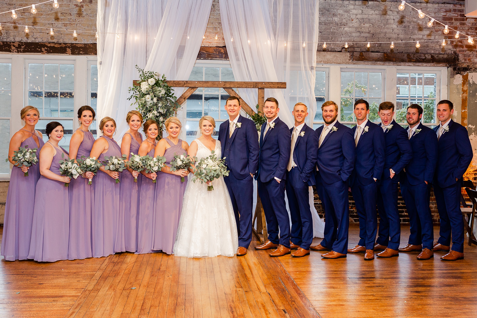 portraits of wedding party by altar in Stockroom at 230