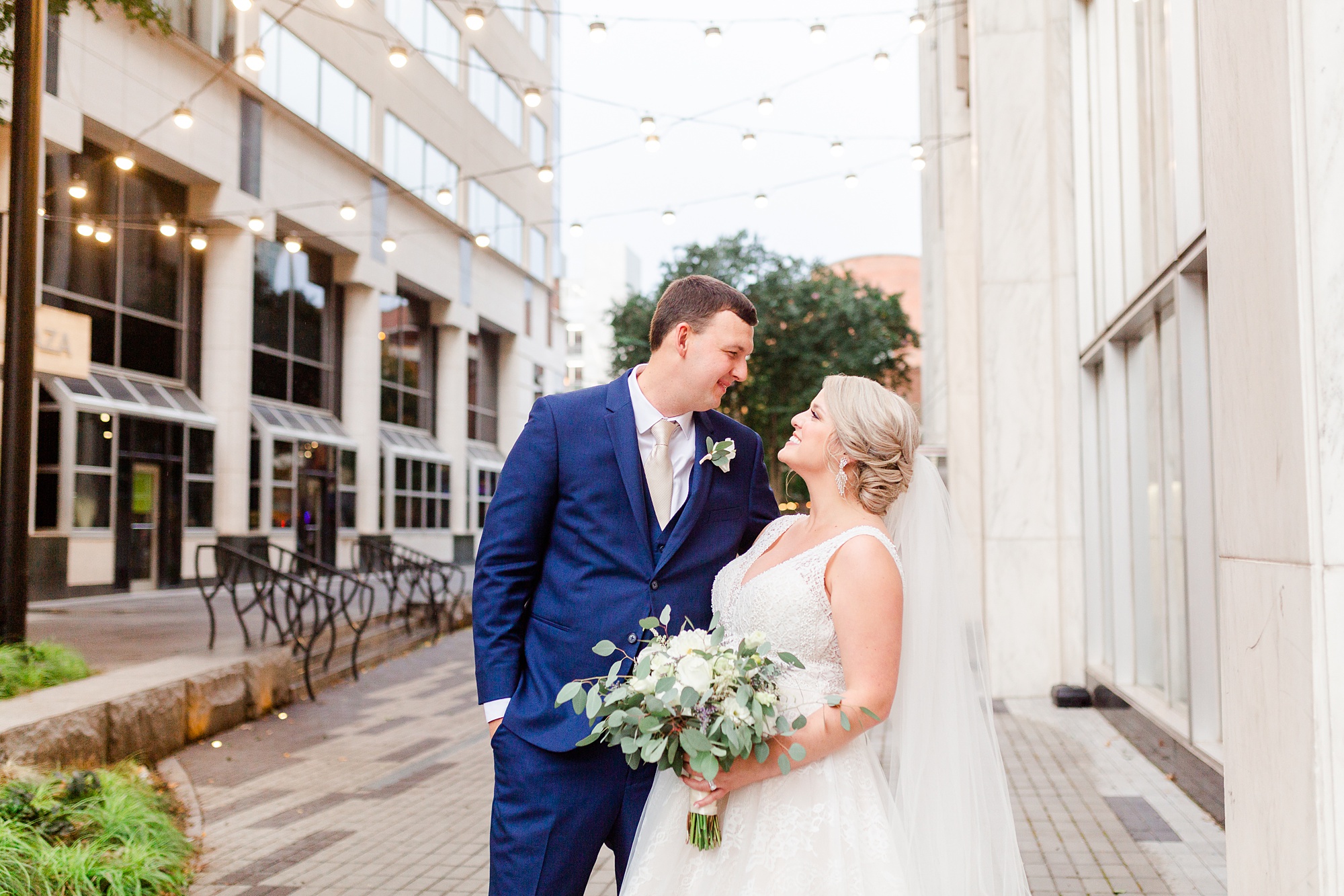 bride and groom look at each other during photos in downtown Raleigh NC