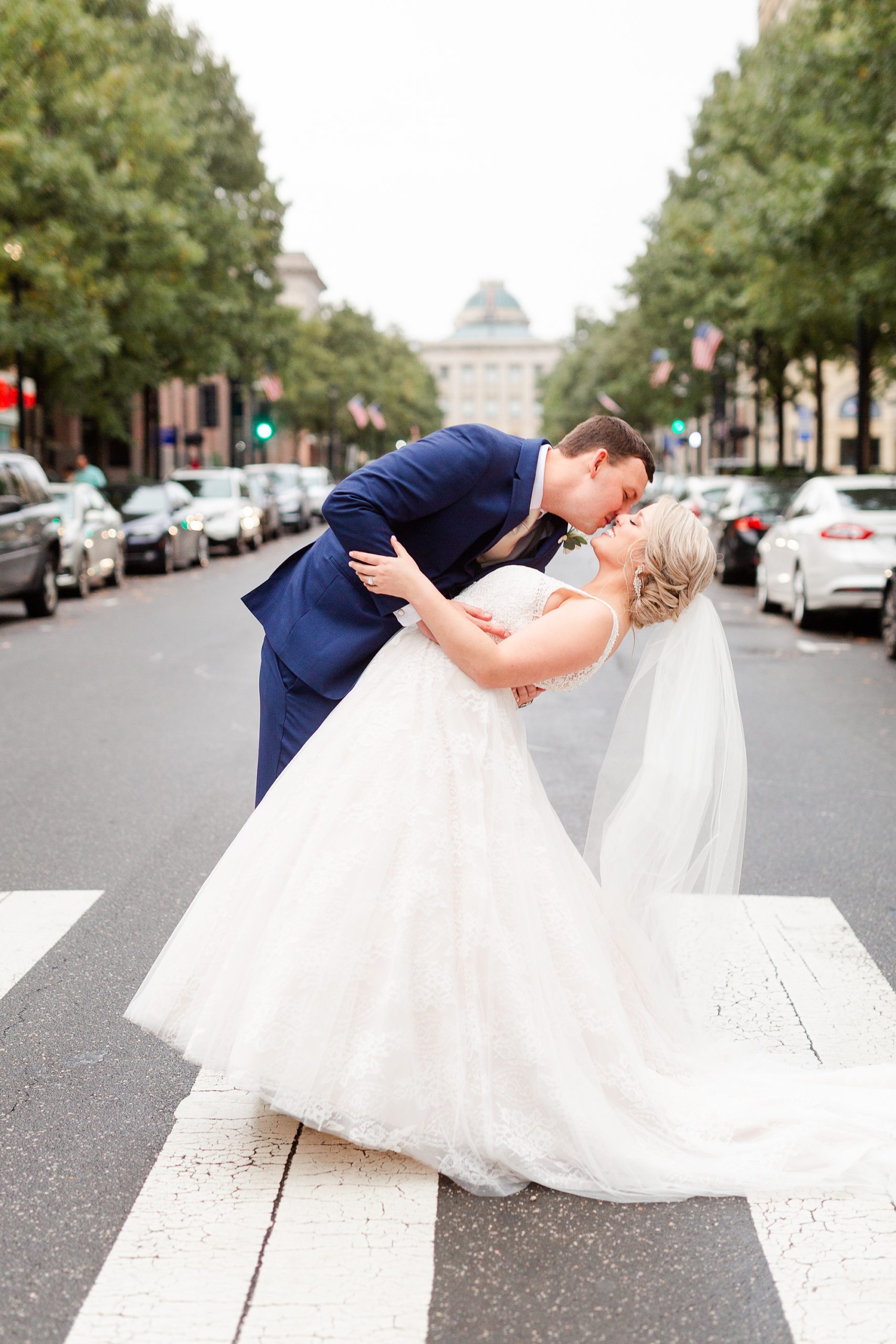 bride and groom kiss in street