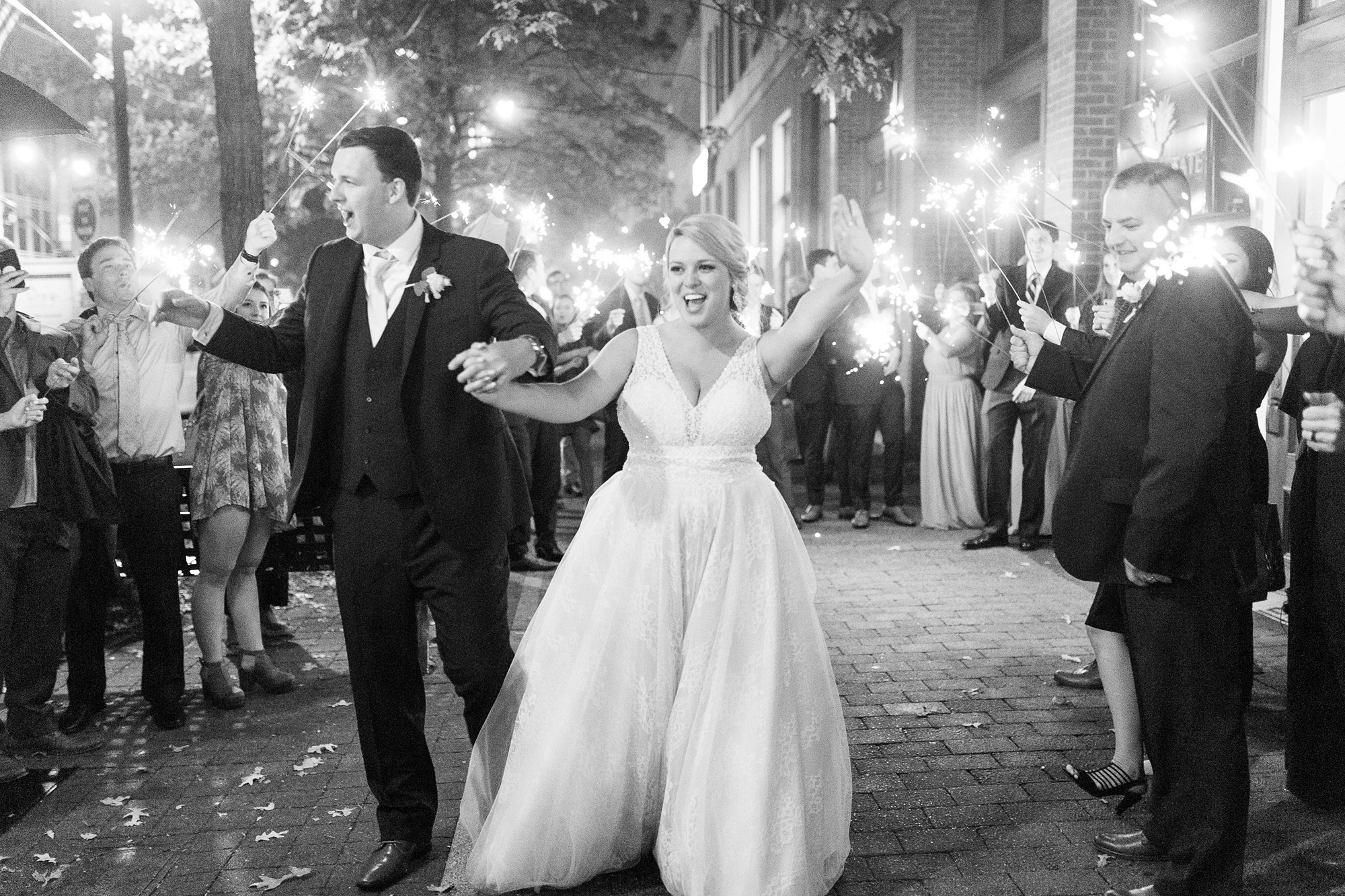 bride and groom cheer during sparkler exit at Stockroom at 230 wedding