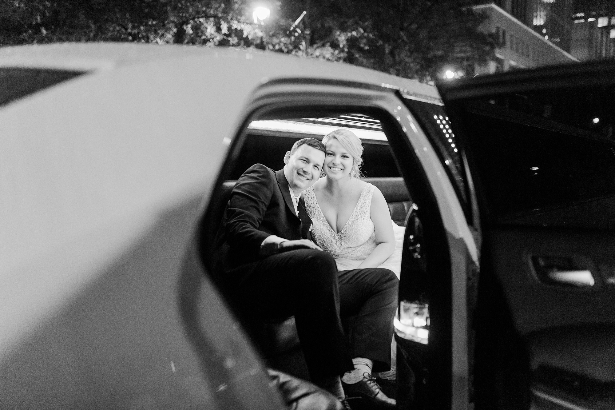 newlyweds leave in classic car from sparkler exit at Stockroom at 230 wedding
