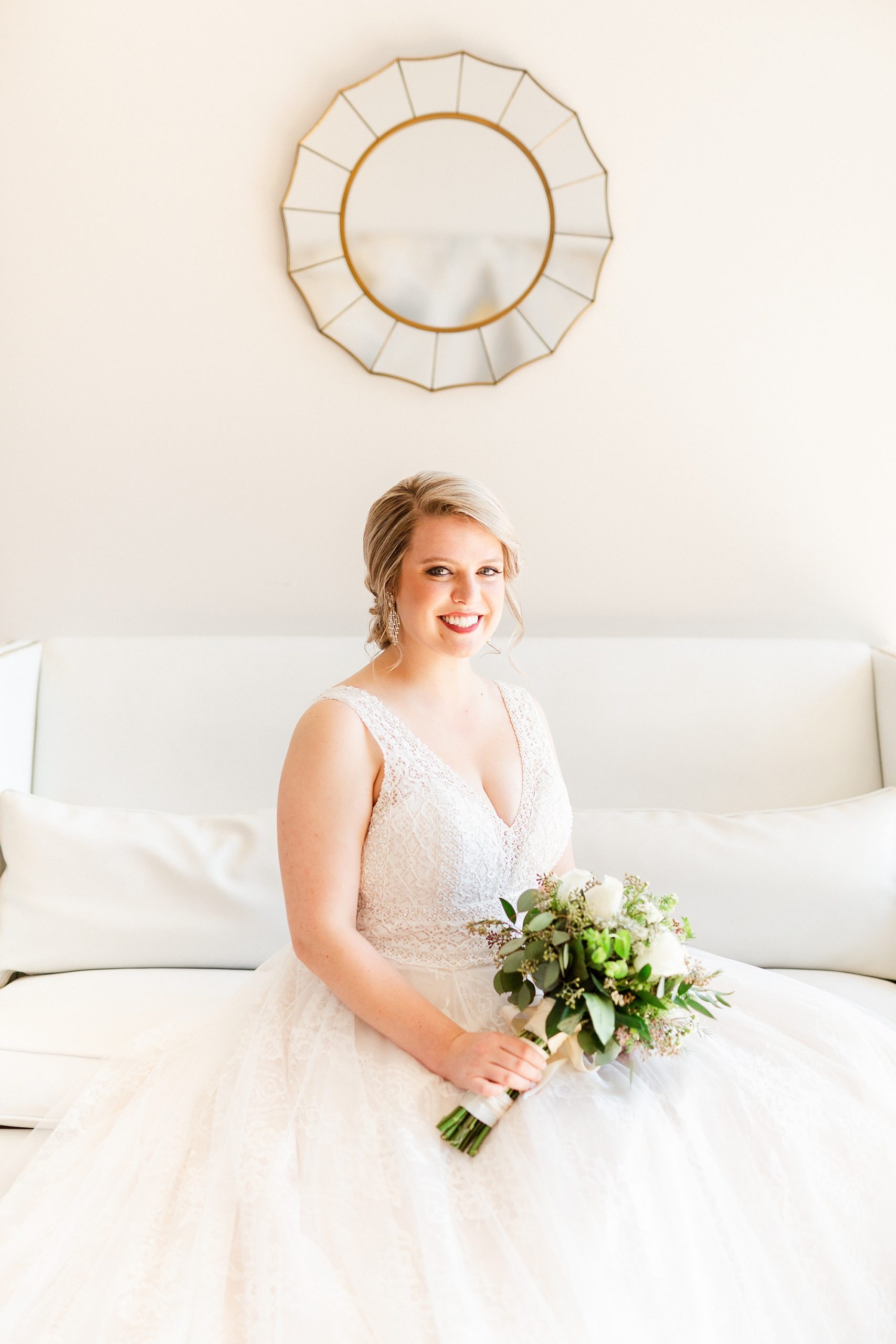 bride sits on couch at the Glass Box