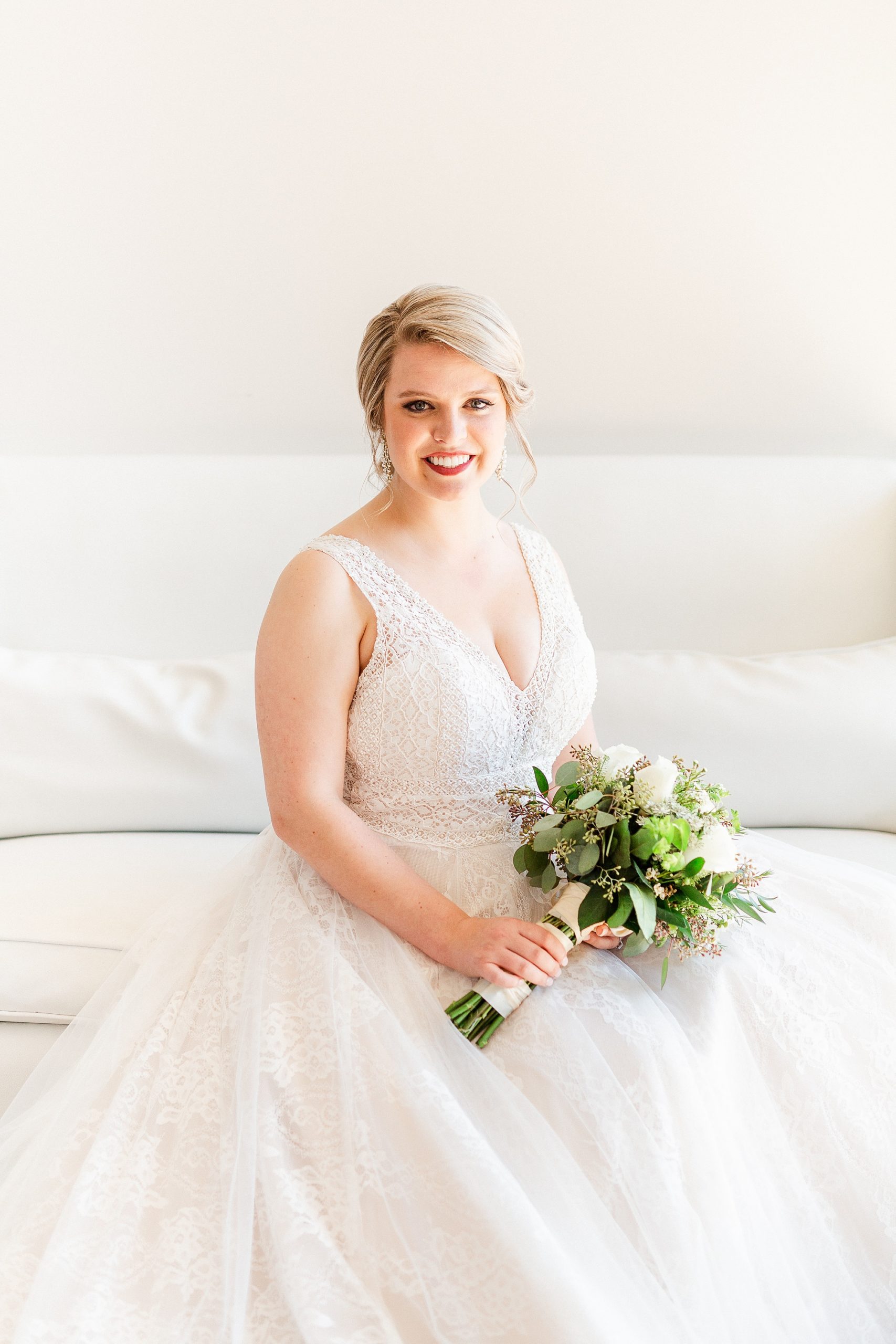 bride poses on couch in Raleigh NC