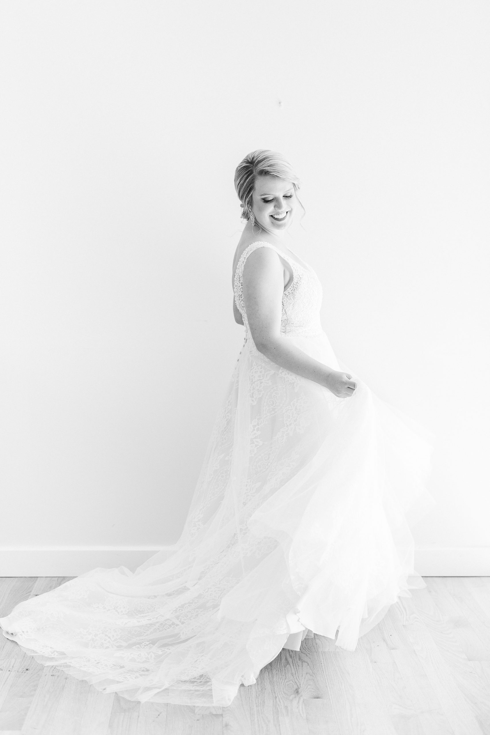 bride twirls wedding gown during The Glass Box bridal photos