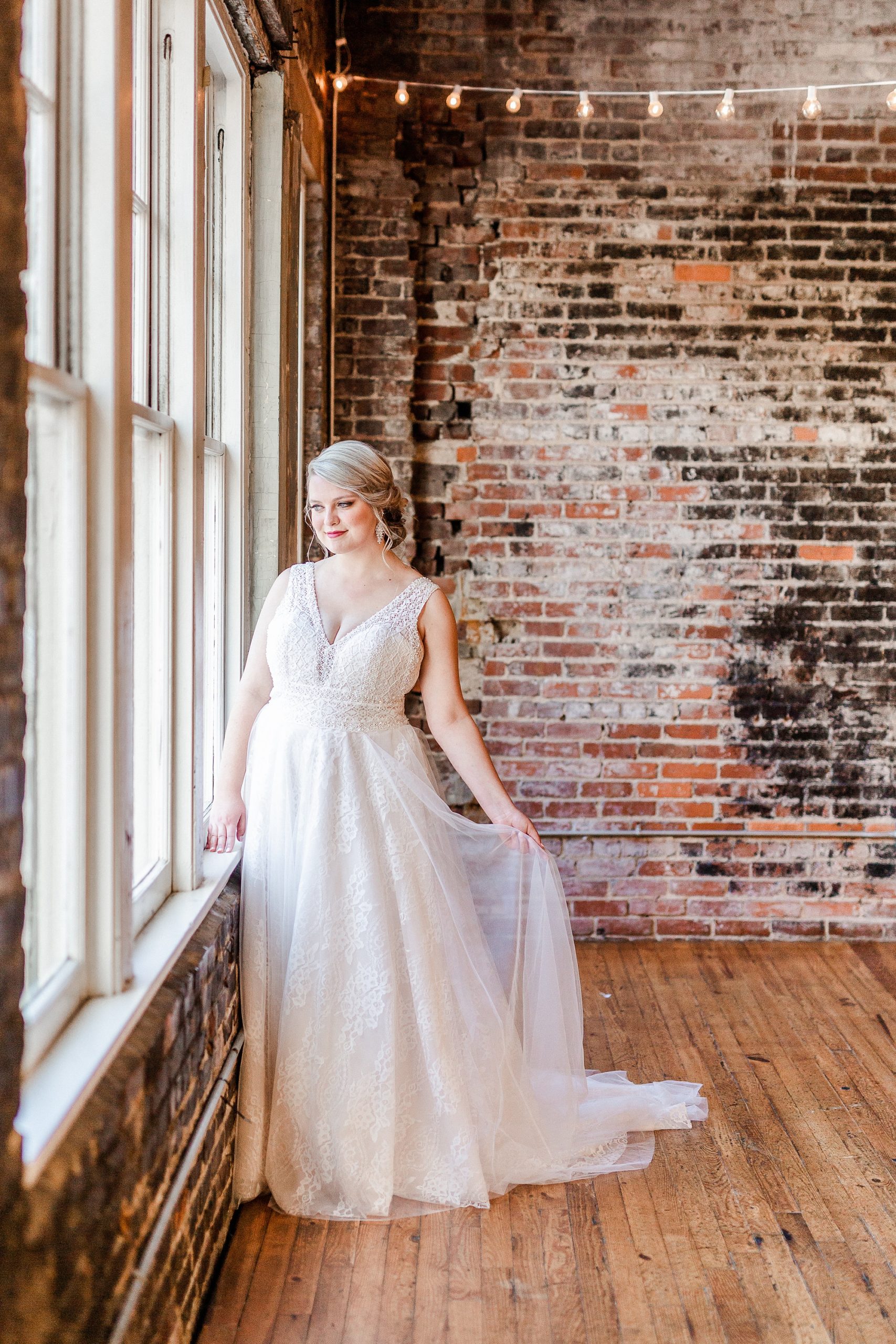 bride looks out window at The Glass Box