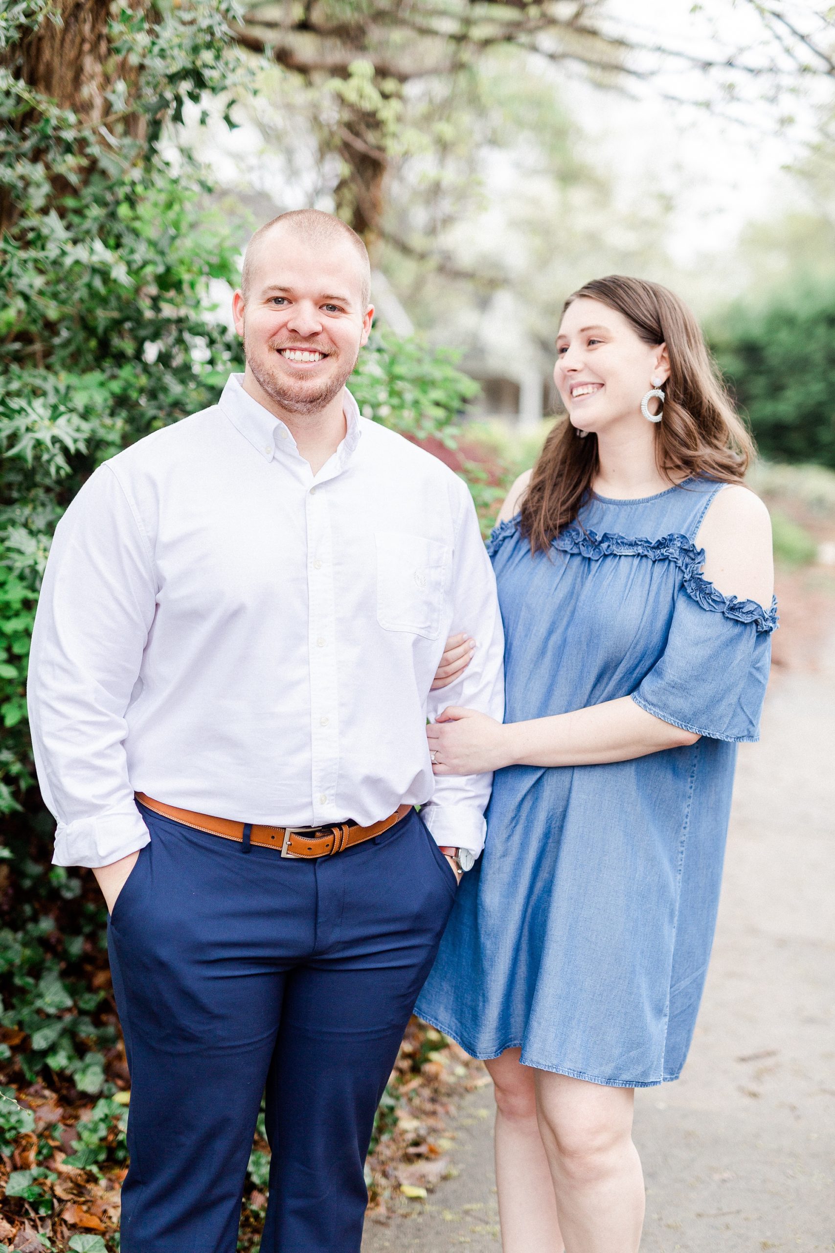 bride laughs at fiancee during engagement photos