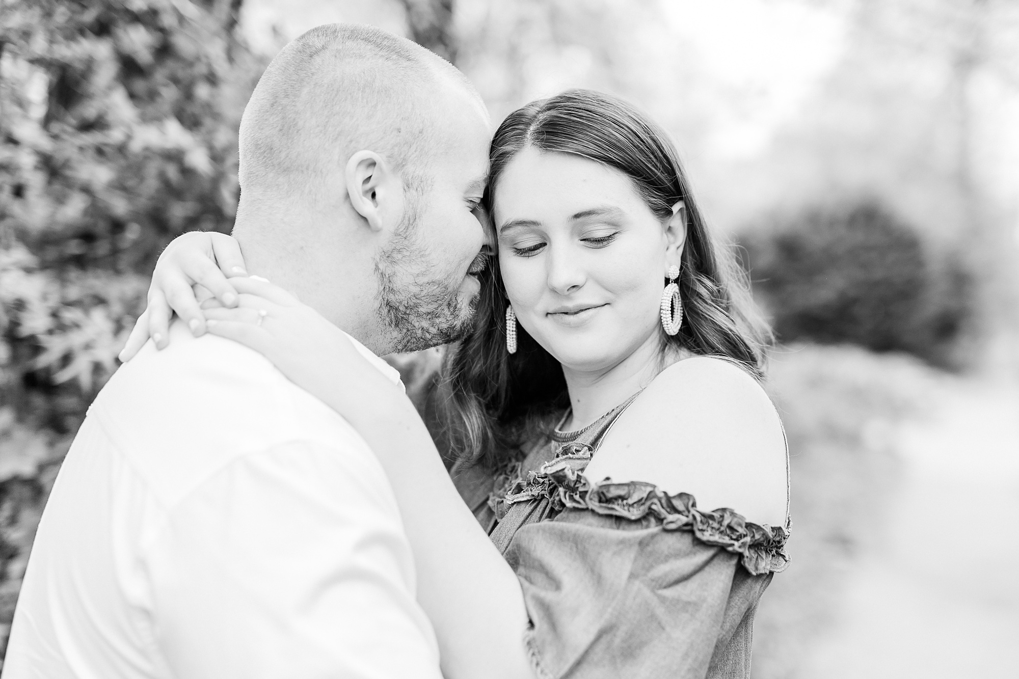 bride and groom pose together along sidewalk in Downtown Davidson
