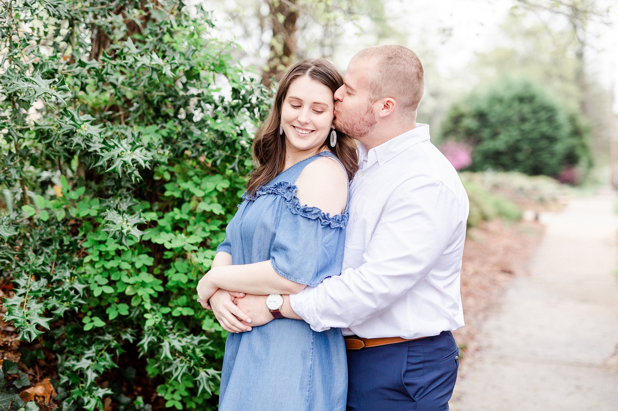 bride and groom hug on sidewalk in Downtown Davidson
