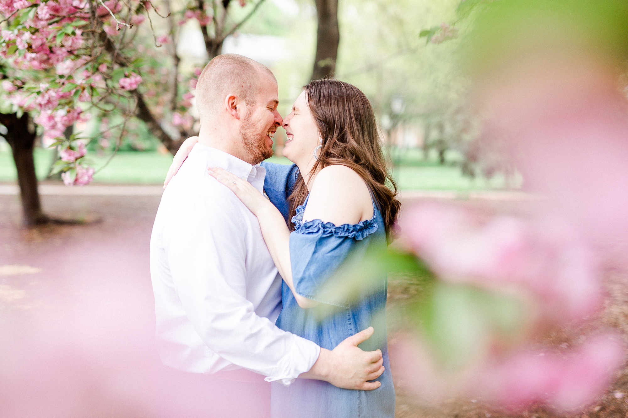 engaged couple laughs in Downtown Davidson