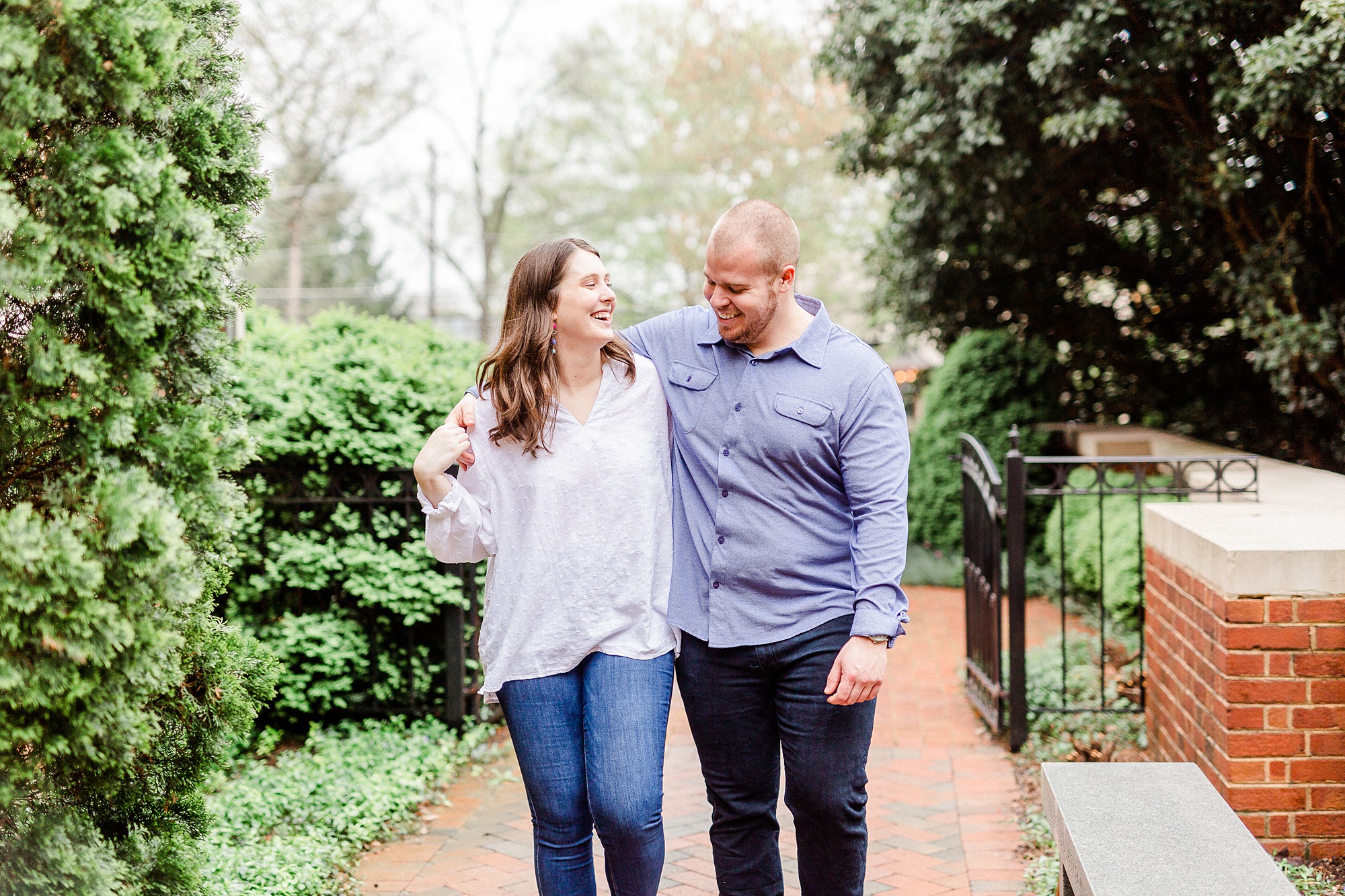 engaged couple walks through Downtown Davidson during engagement photos