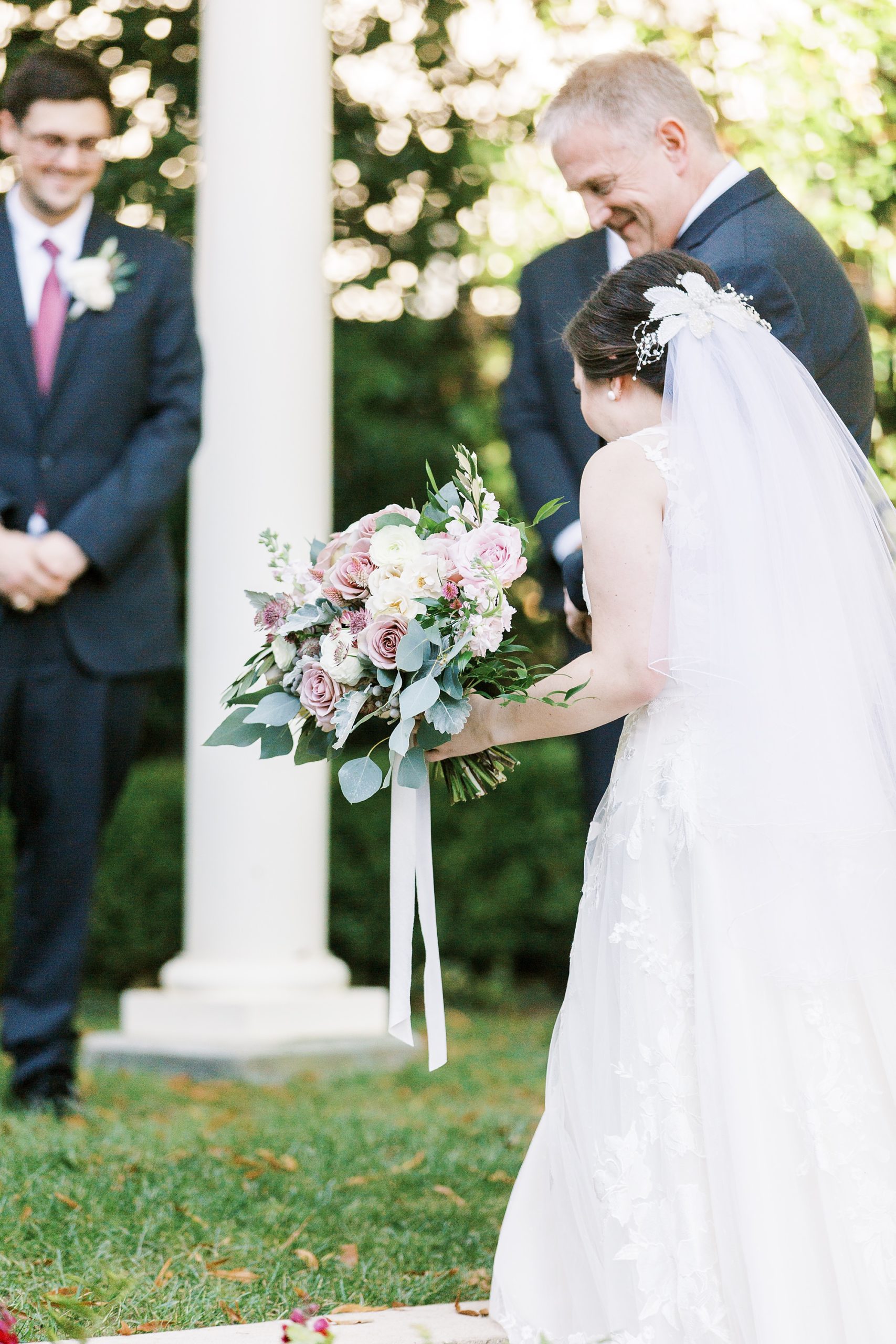 bride walks up steps at Separk Mansion with dad