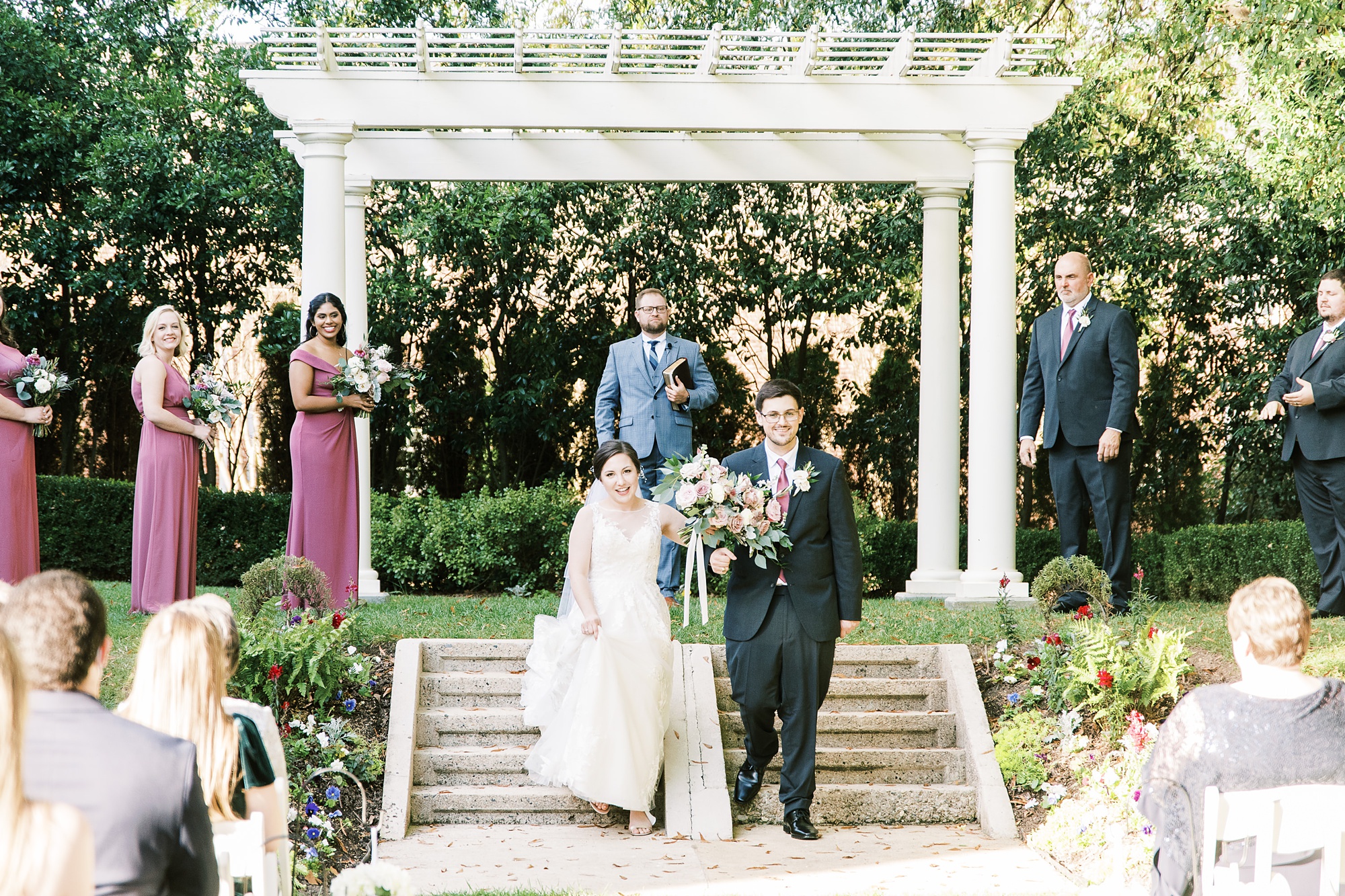 married couple walks down steps at Separk Mansion to greet guests