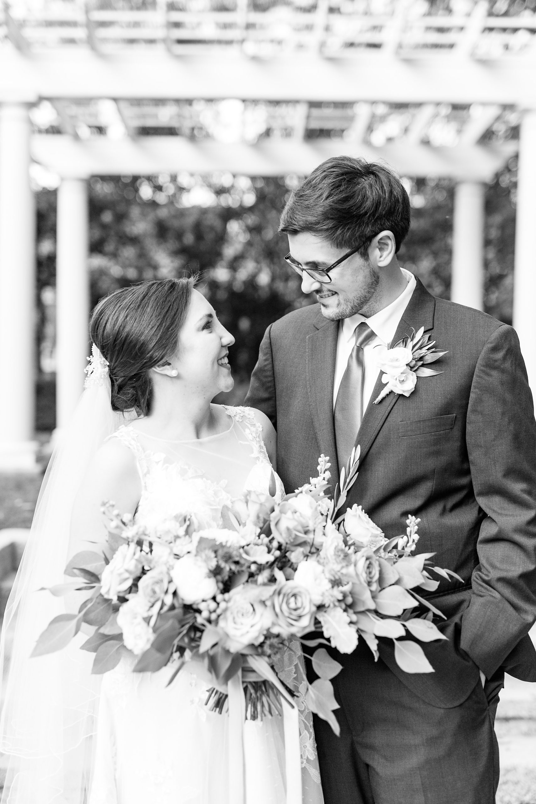 newlyweds look at each other during wedding photos in Charlotte NC