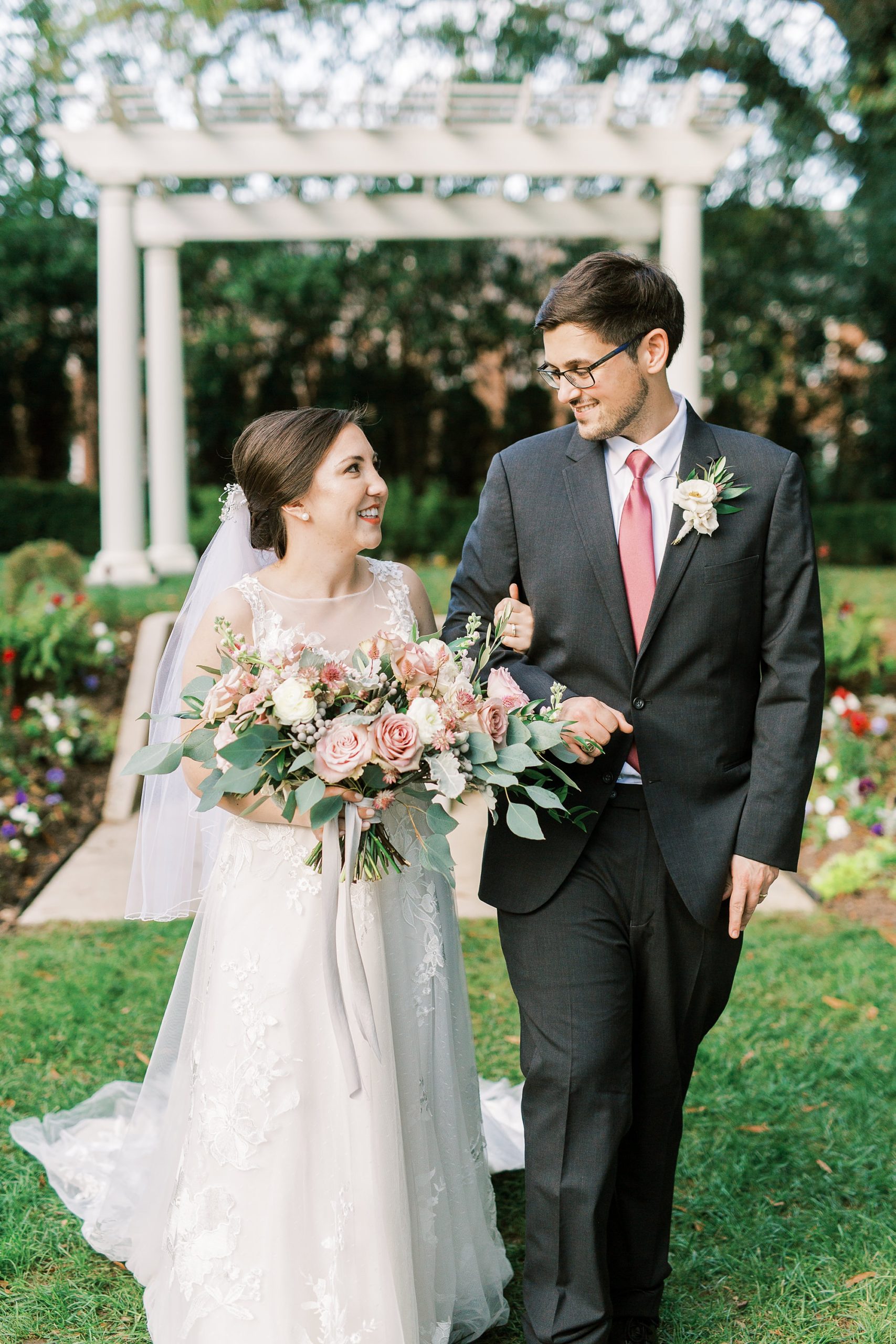 newlyweds walk through garden at Separk Mansion