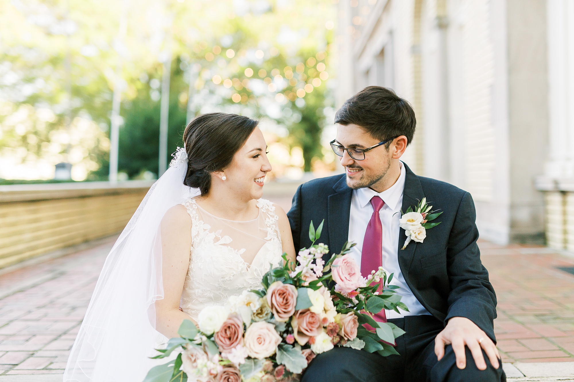 newlyweds laugh together on steps at Separk Mansion