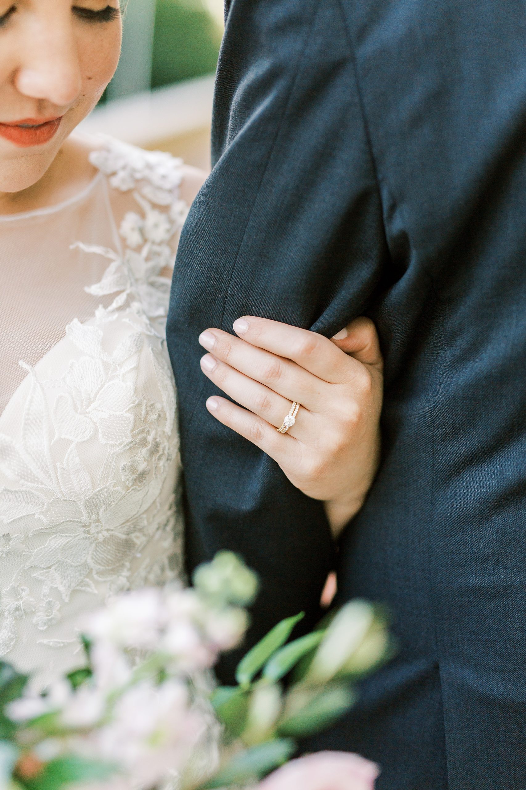 bride holds groom's arm during portraits in North Carolina