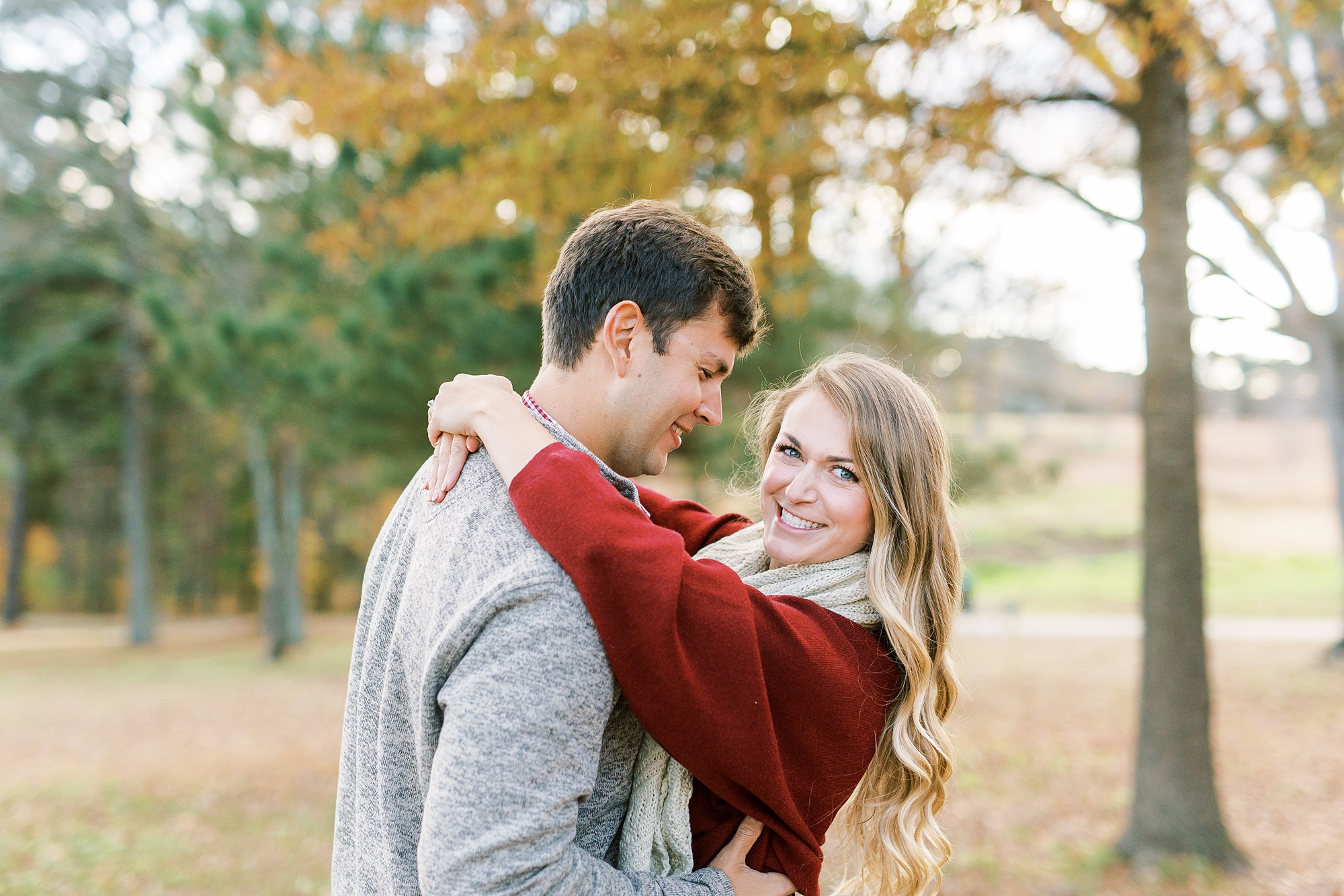 groom looks down at bride during engagement photos