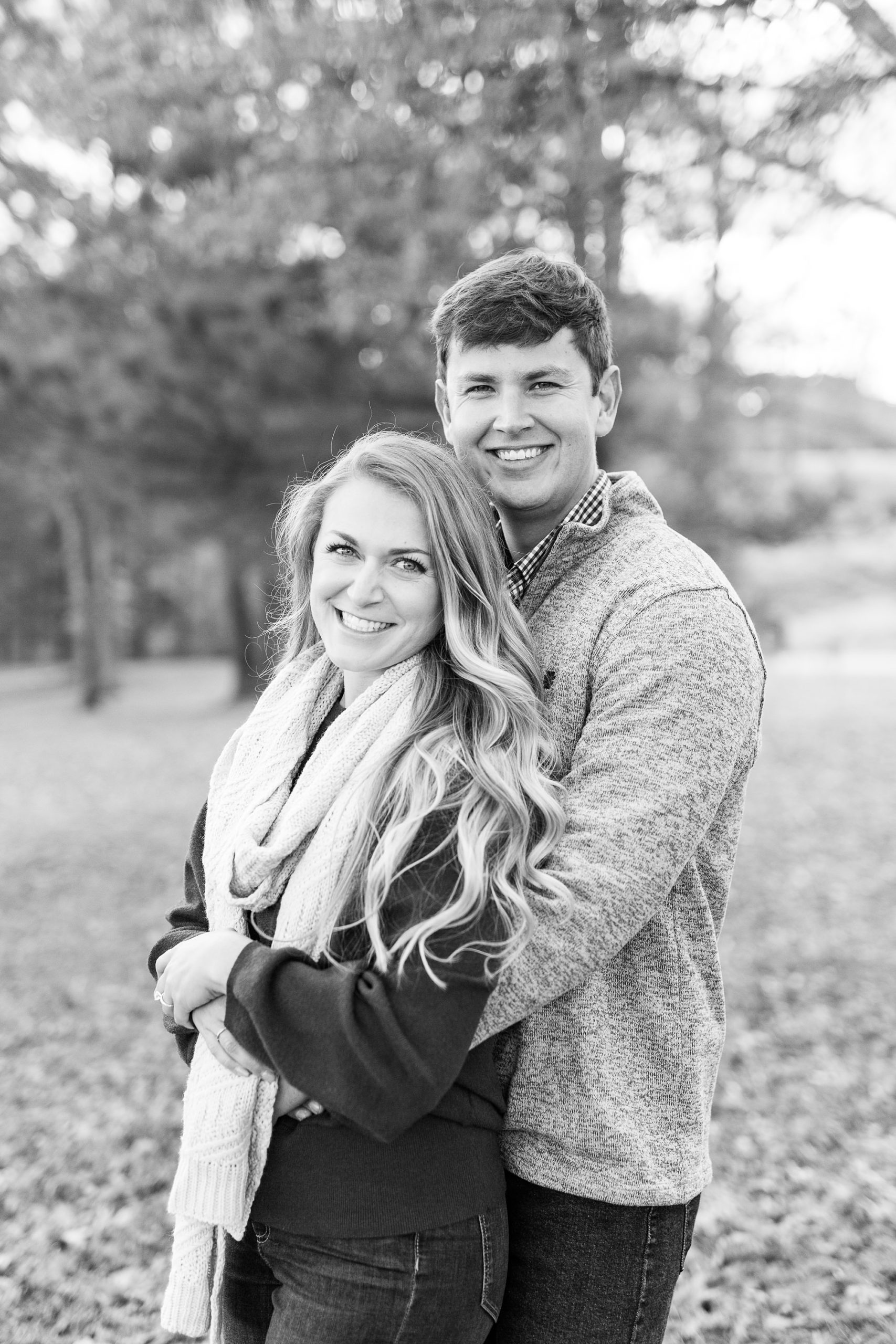 black and white portrait of engaged couple during the fall