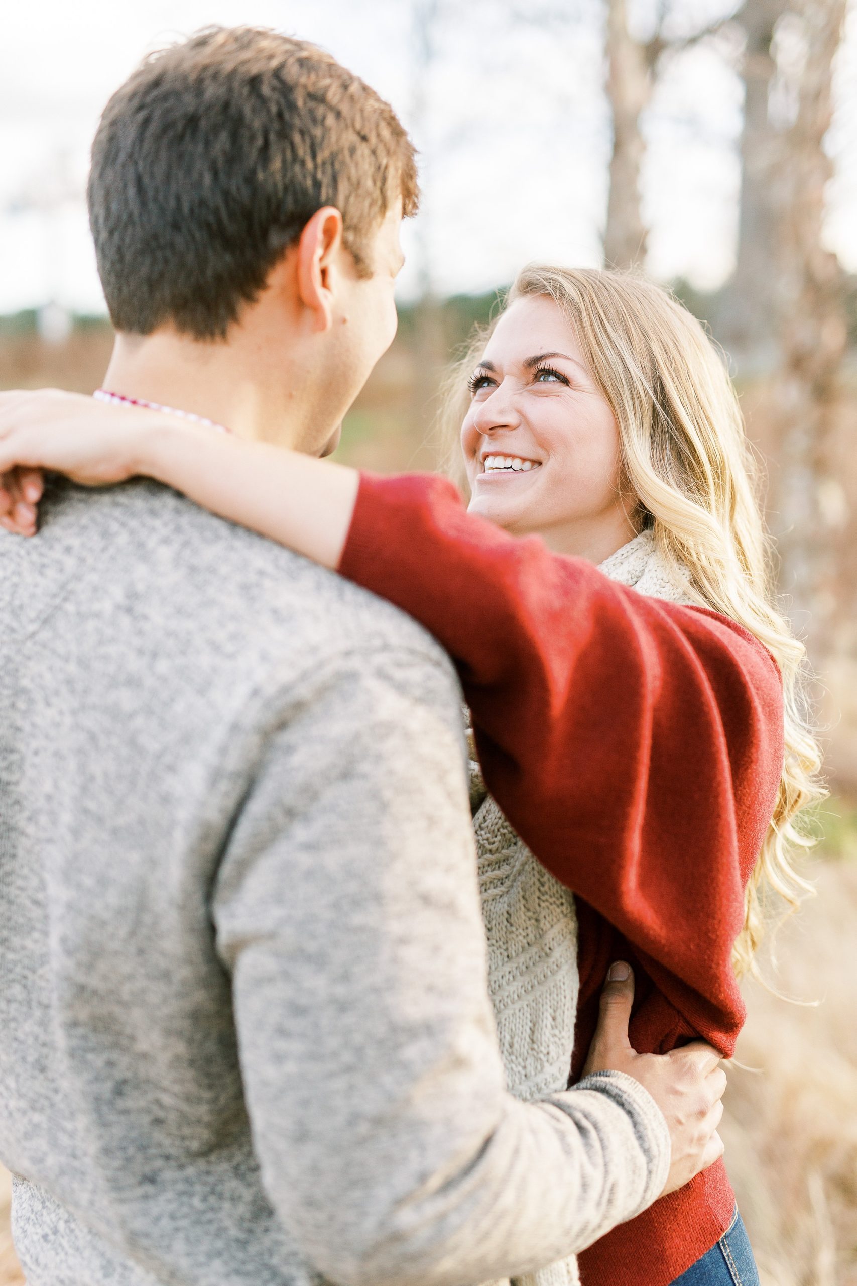 bride looks up at groom during fall engagement photos in Raleigh NC