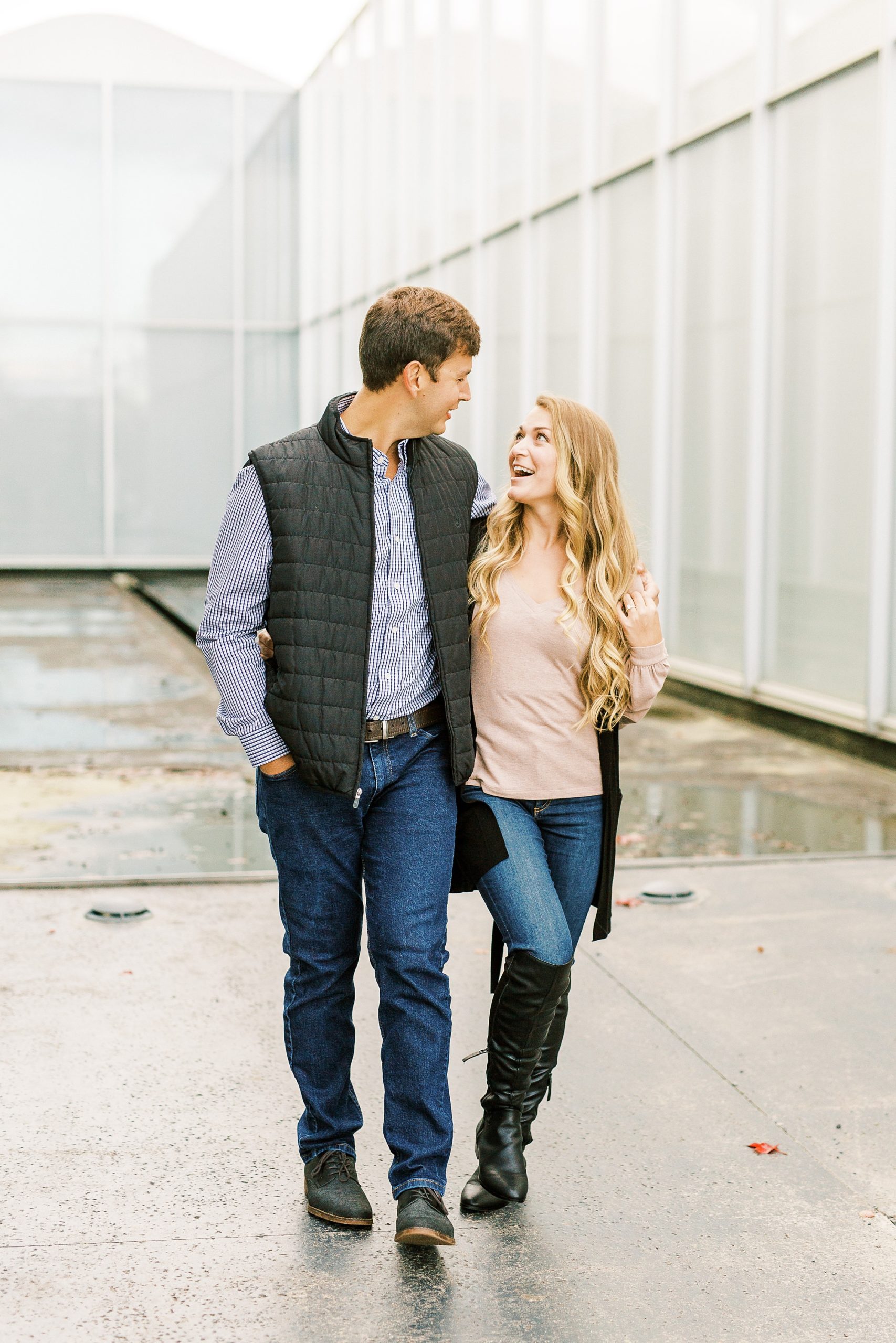 couple walks through NC Museum of Art during engagement photos