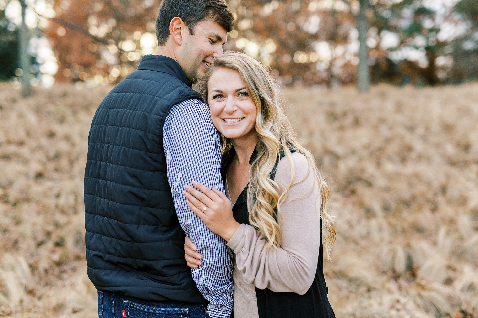 bride leans against groom during NC Museum of Art engagement photos