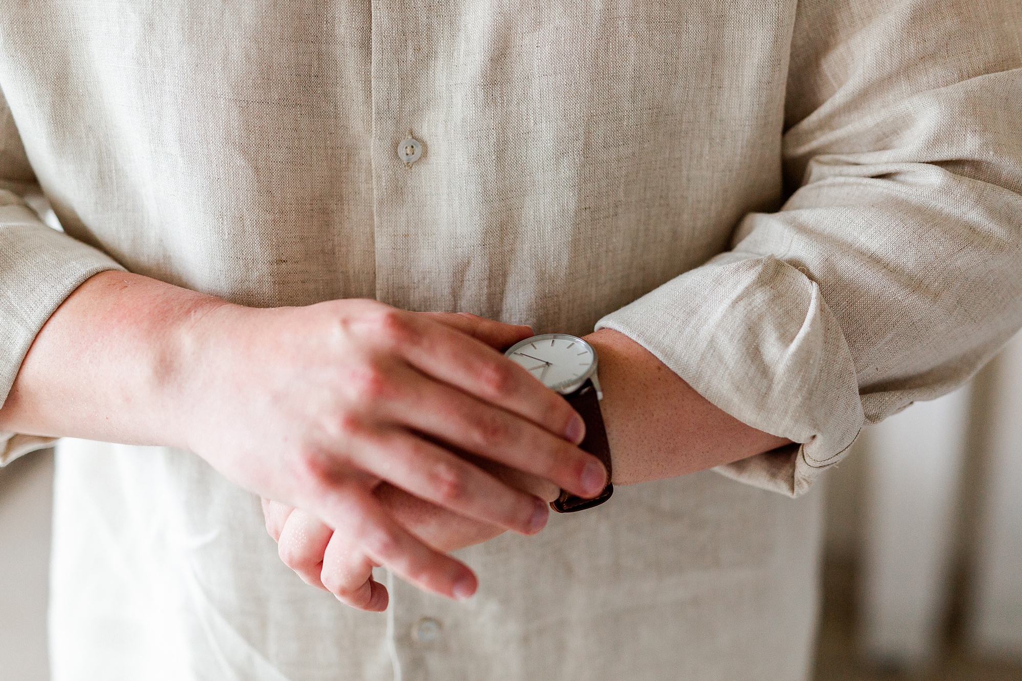 groom adjusts watch while preparing for St Lucia resort wedding