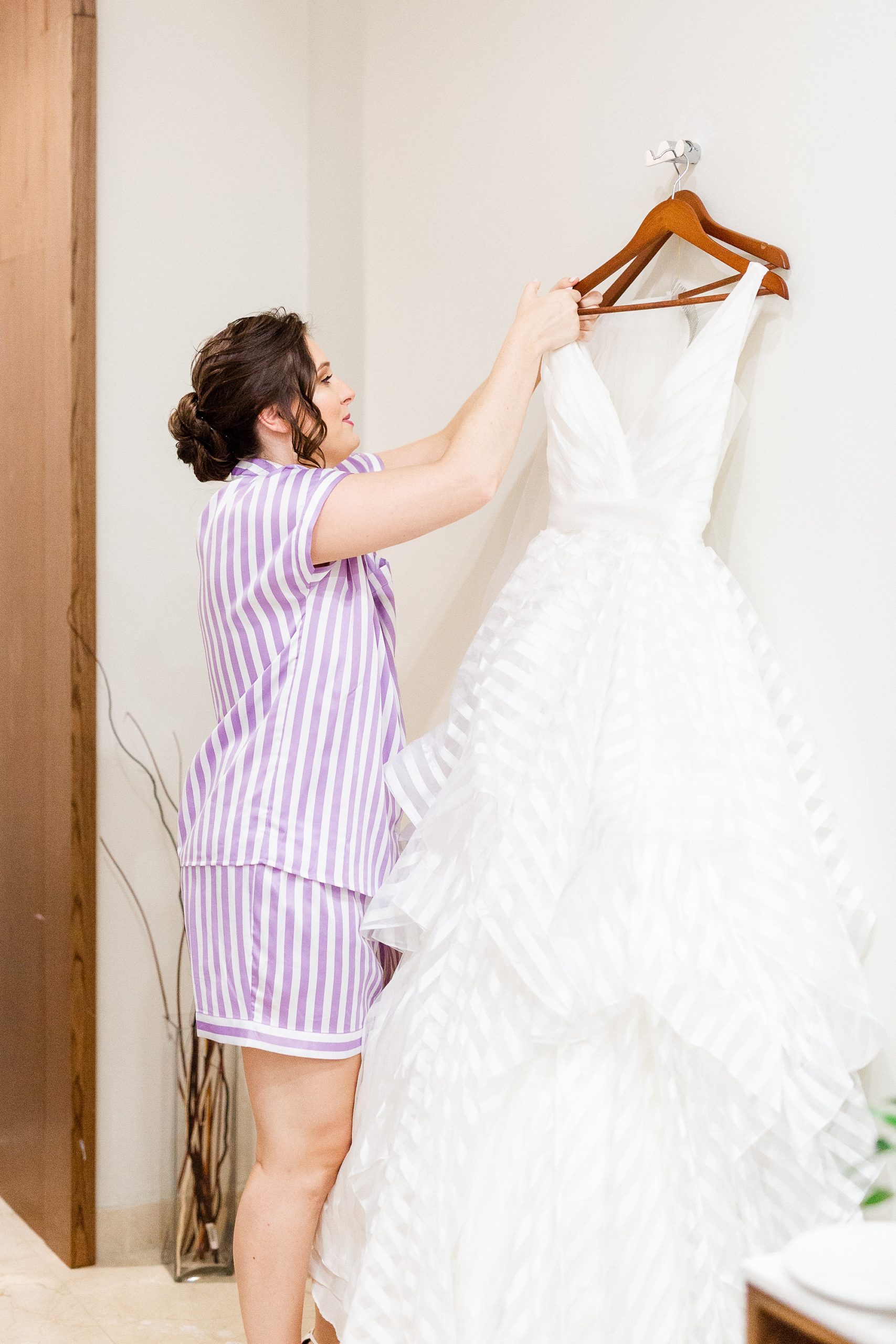 bride looks ta wedding dress