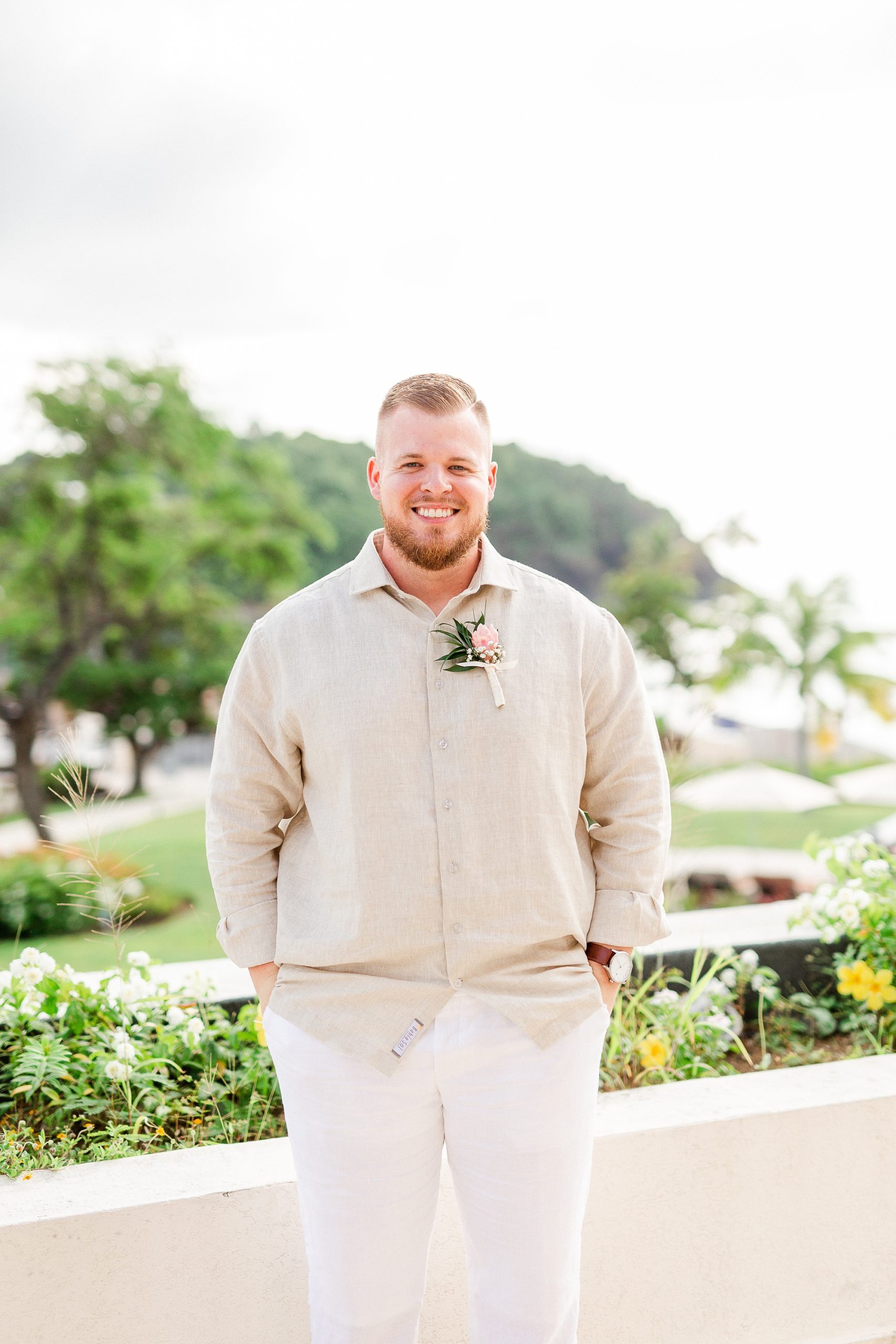 groom in beach wedding attire poses at Royalton Resort
