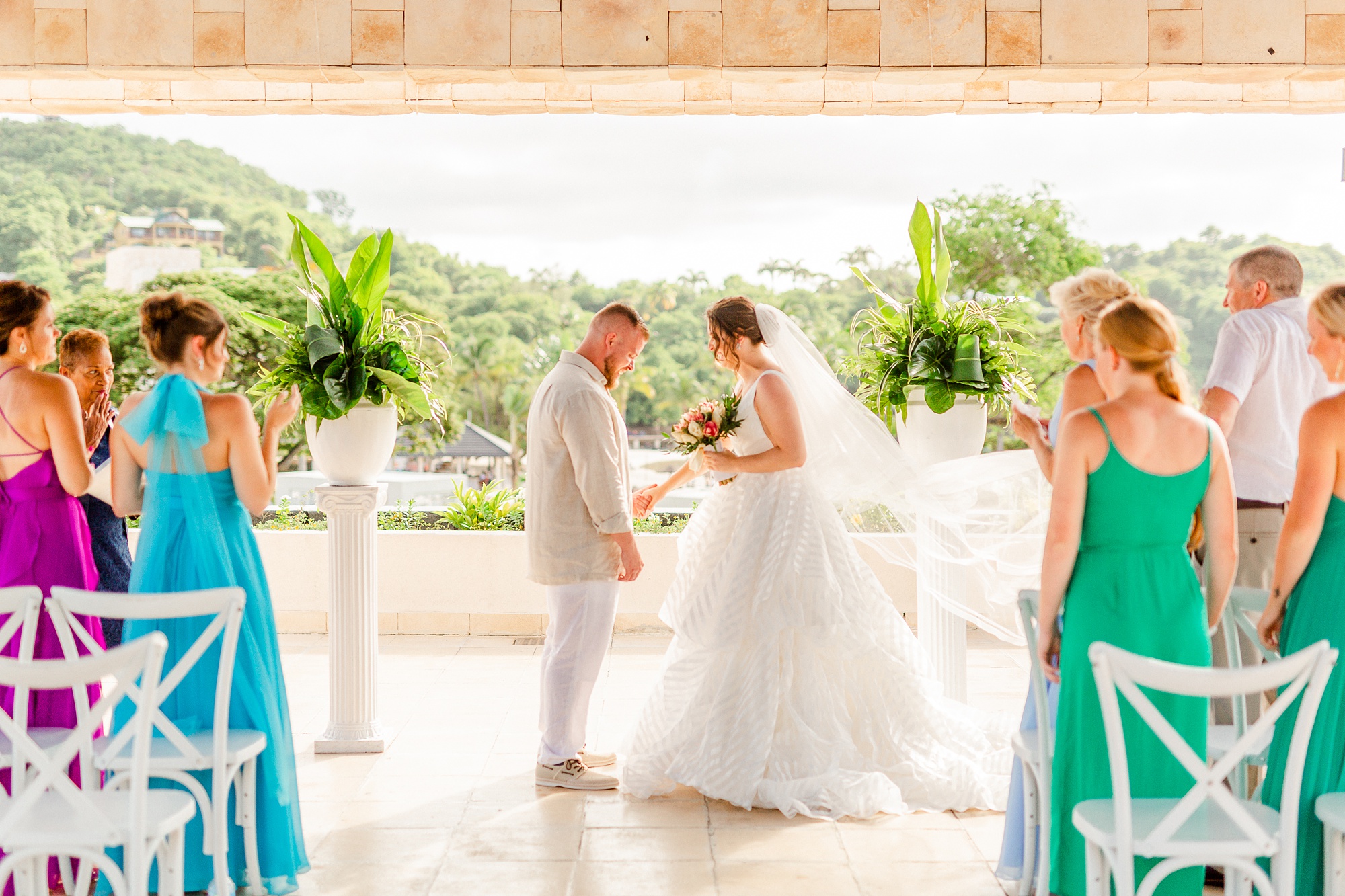 bride and groom smile during ceremony