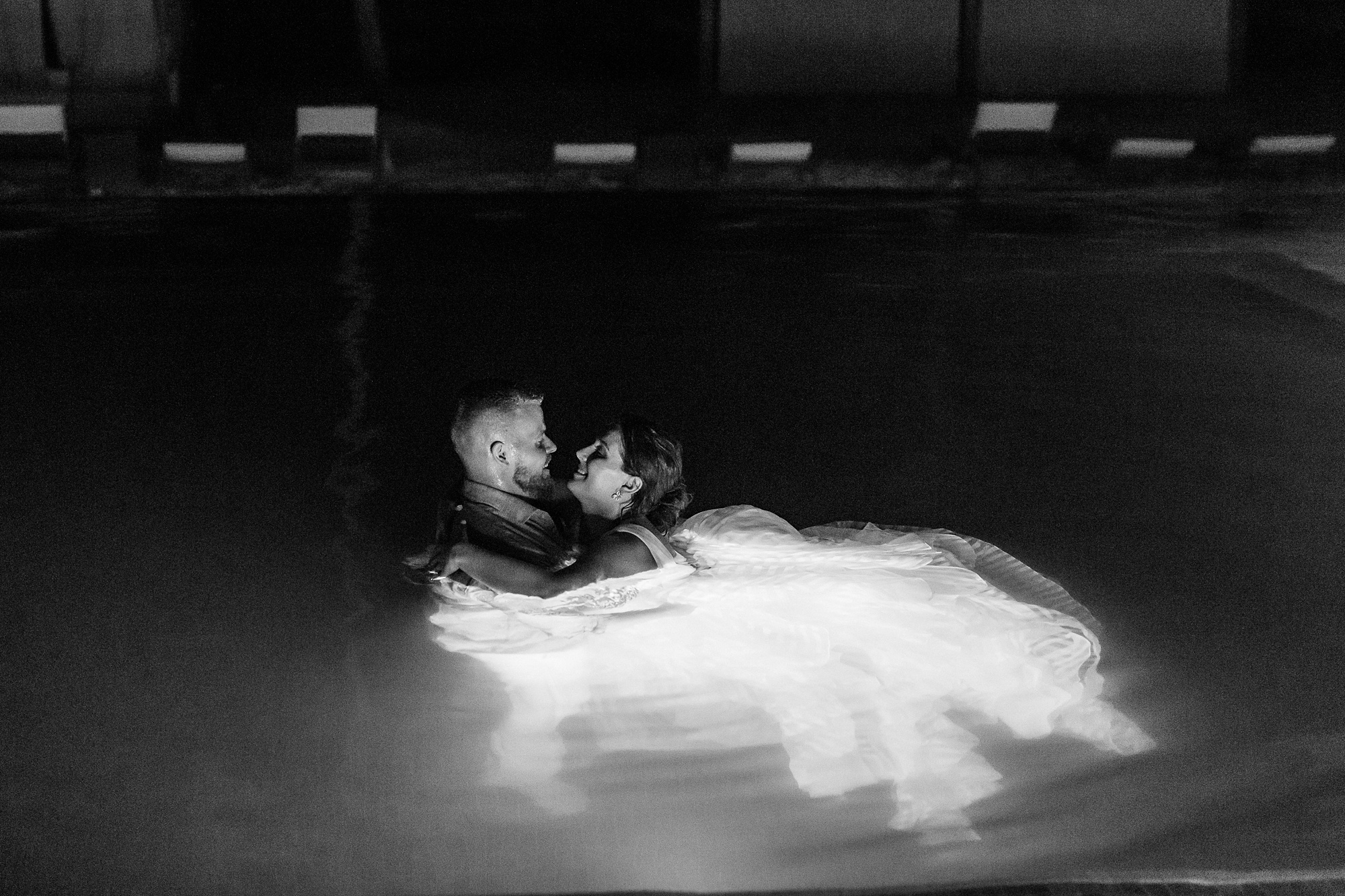 bride and groom jump into pool after St Lucia resort wedding
