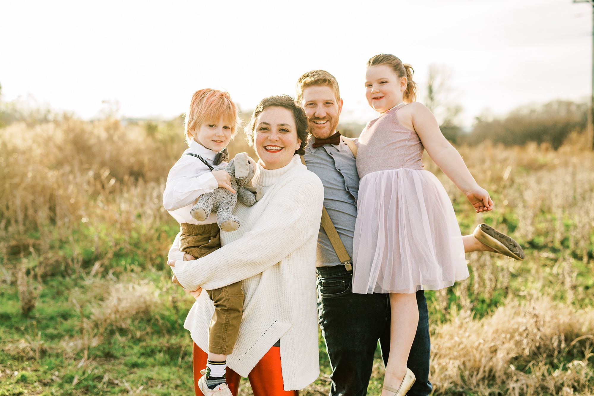family of four poses during winter family portraits