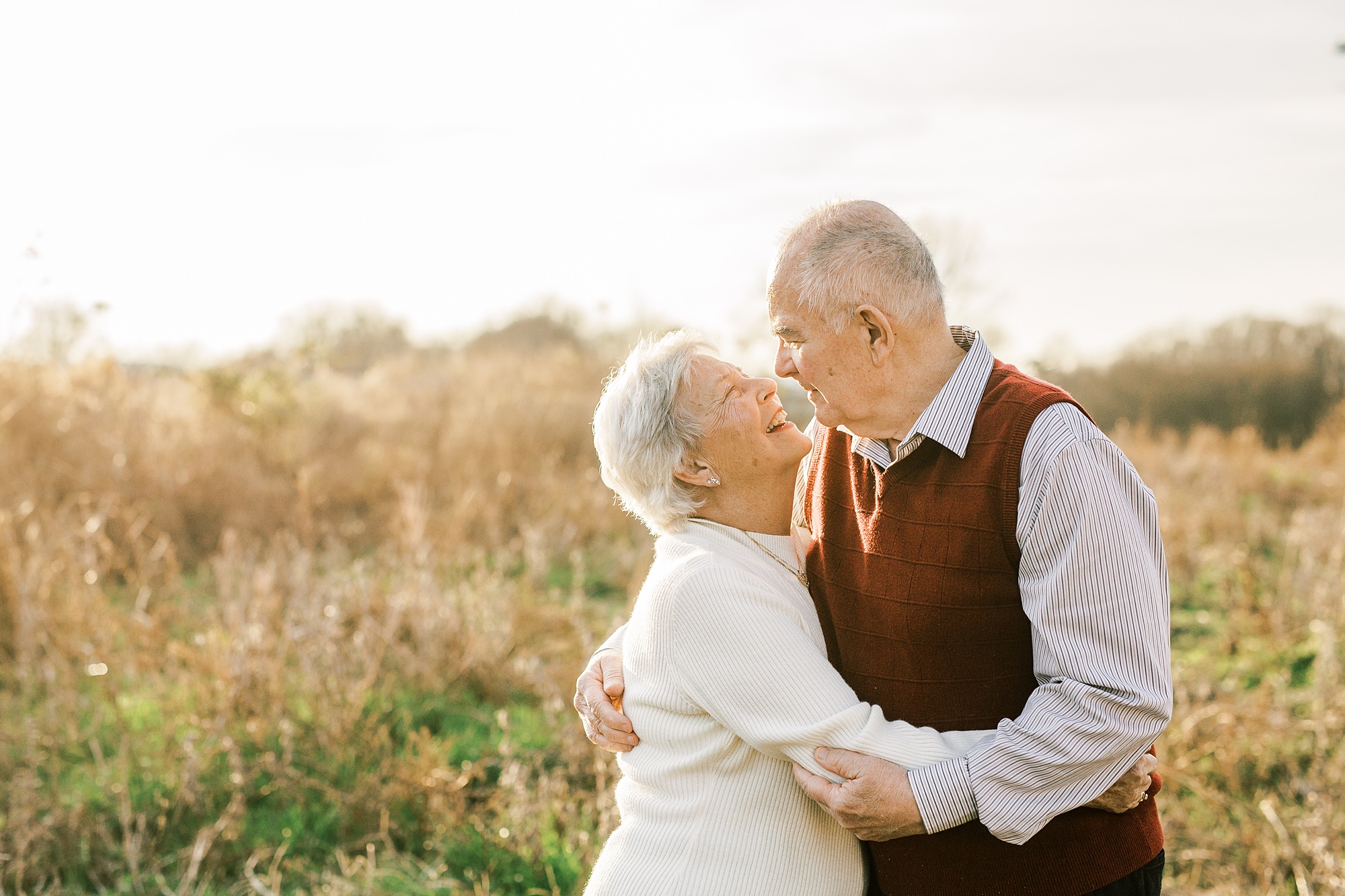 husband and wife kiss during 50th anniversary photos