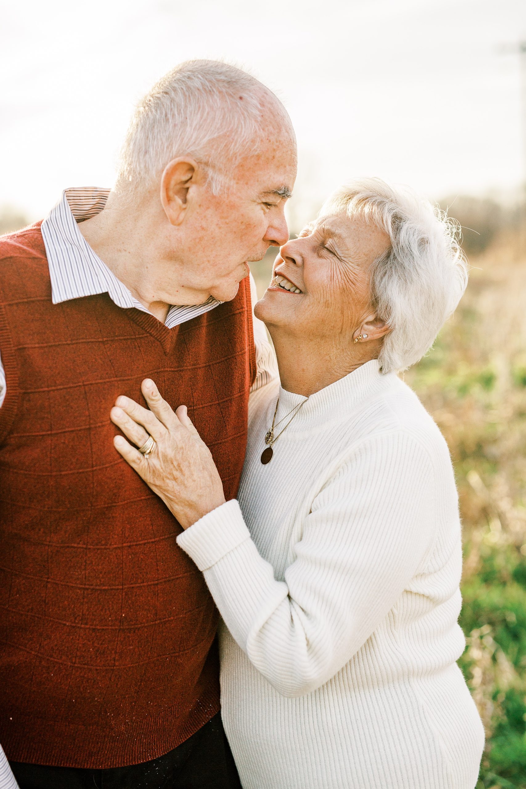 couple laughs during 50th anniversary photos in field