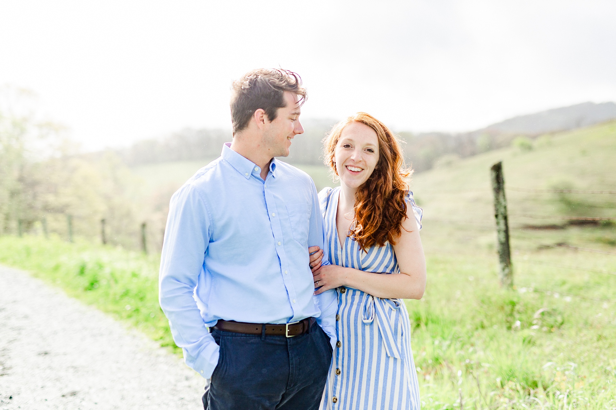 engaged couple walks on dirt path at Moses Cone Manor
