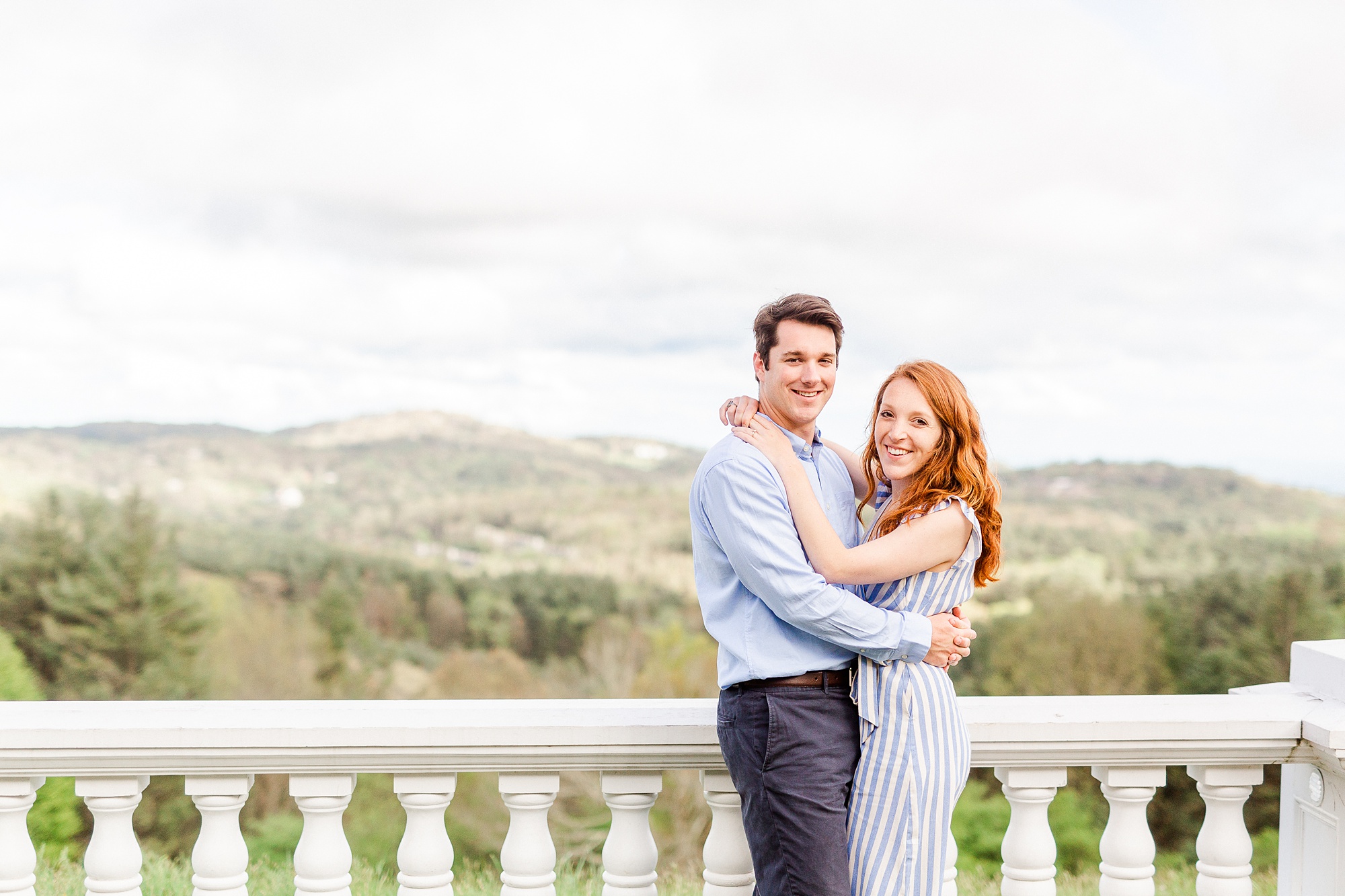 couple hugs on the balcony of Moses Cone Manor
